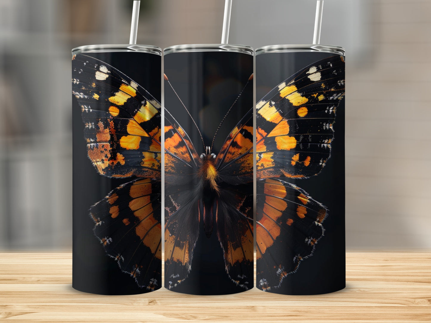 Triptych of tumblers featuring a detailed orange and black butterfly wing design.