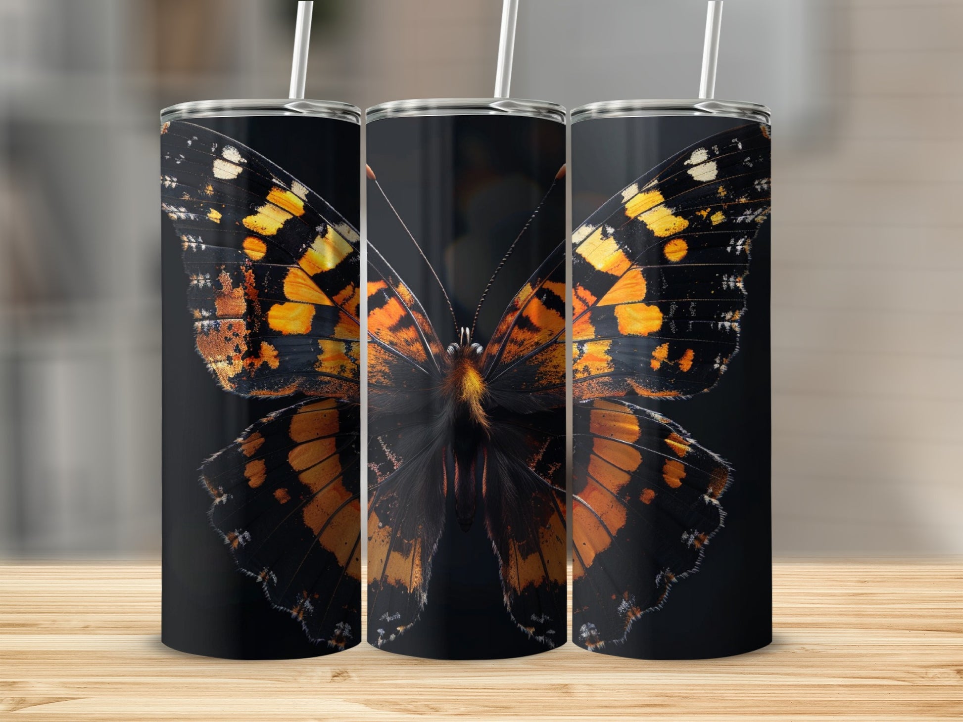 Triptych of tumblers featuring a detailed orange and black butterfly wing design.