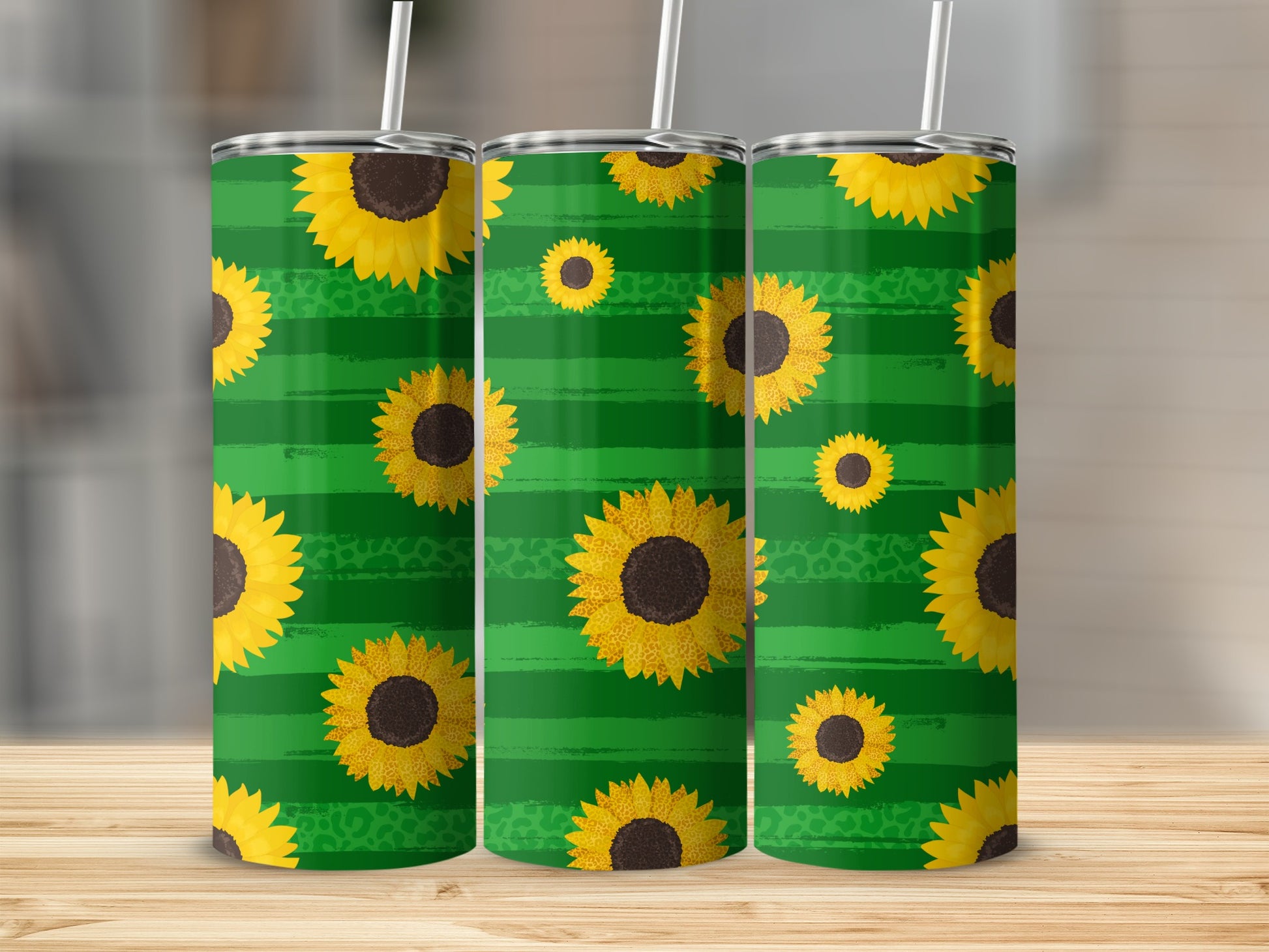Three tall tumblers with a green striped and sunflower pattern.