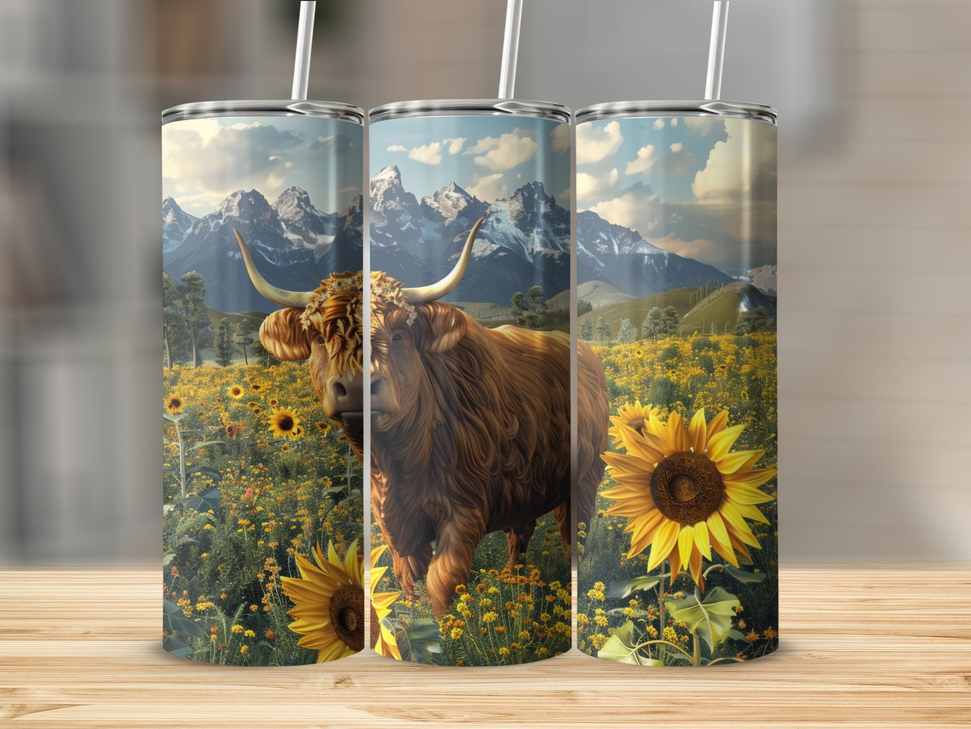 Highland cow and sunflowers in a mountain landscape on three tumblers.