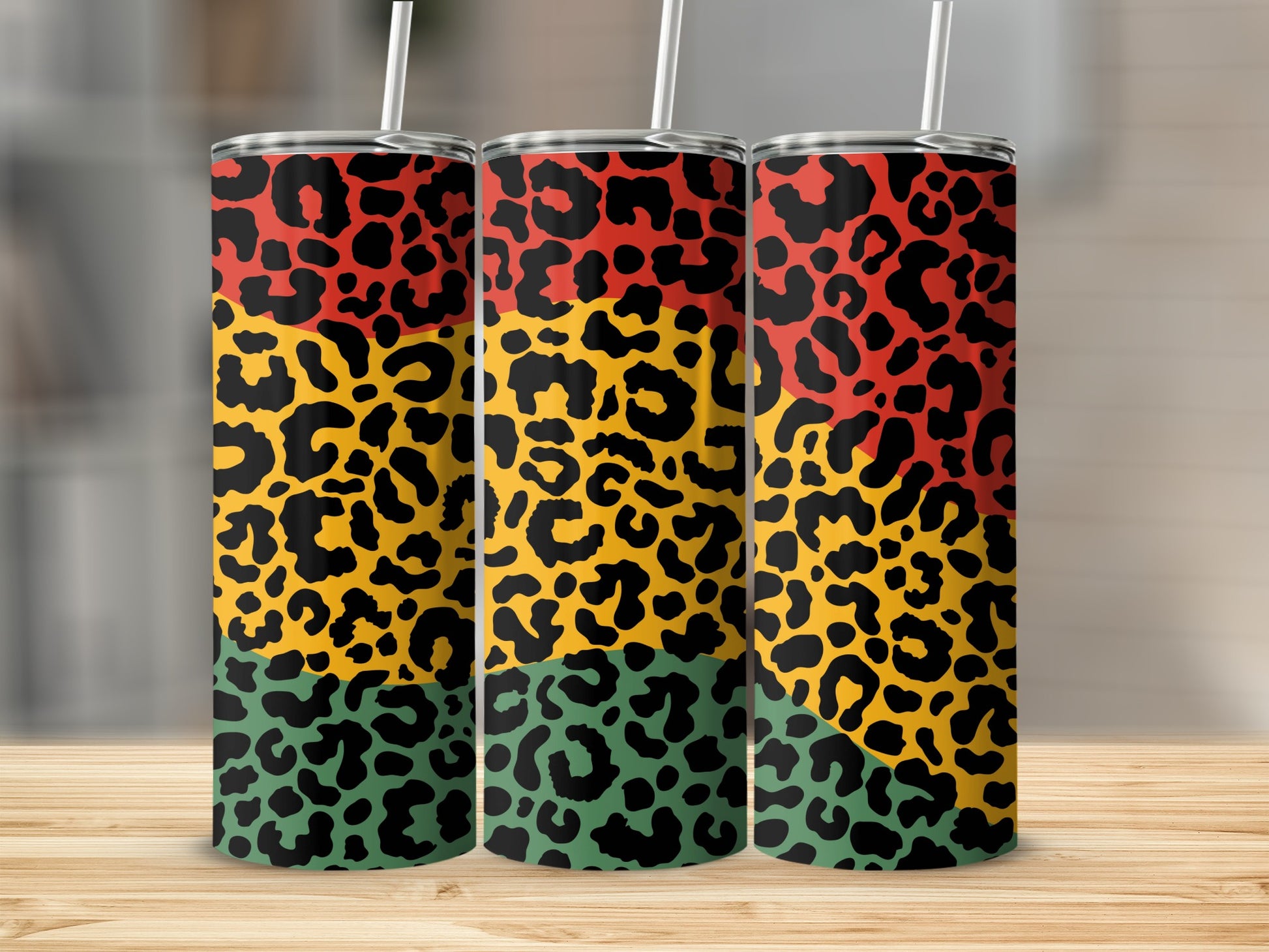Three tumblers with red, yellow, and green leopard print patterns.