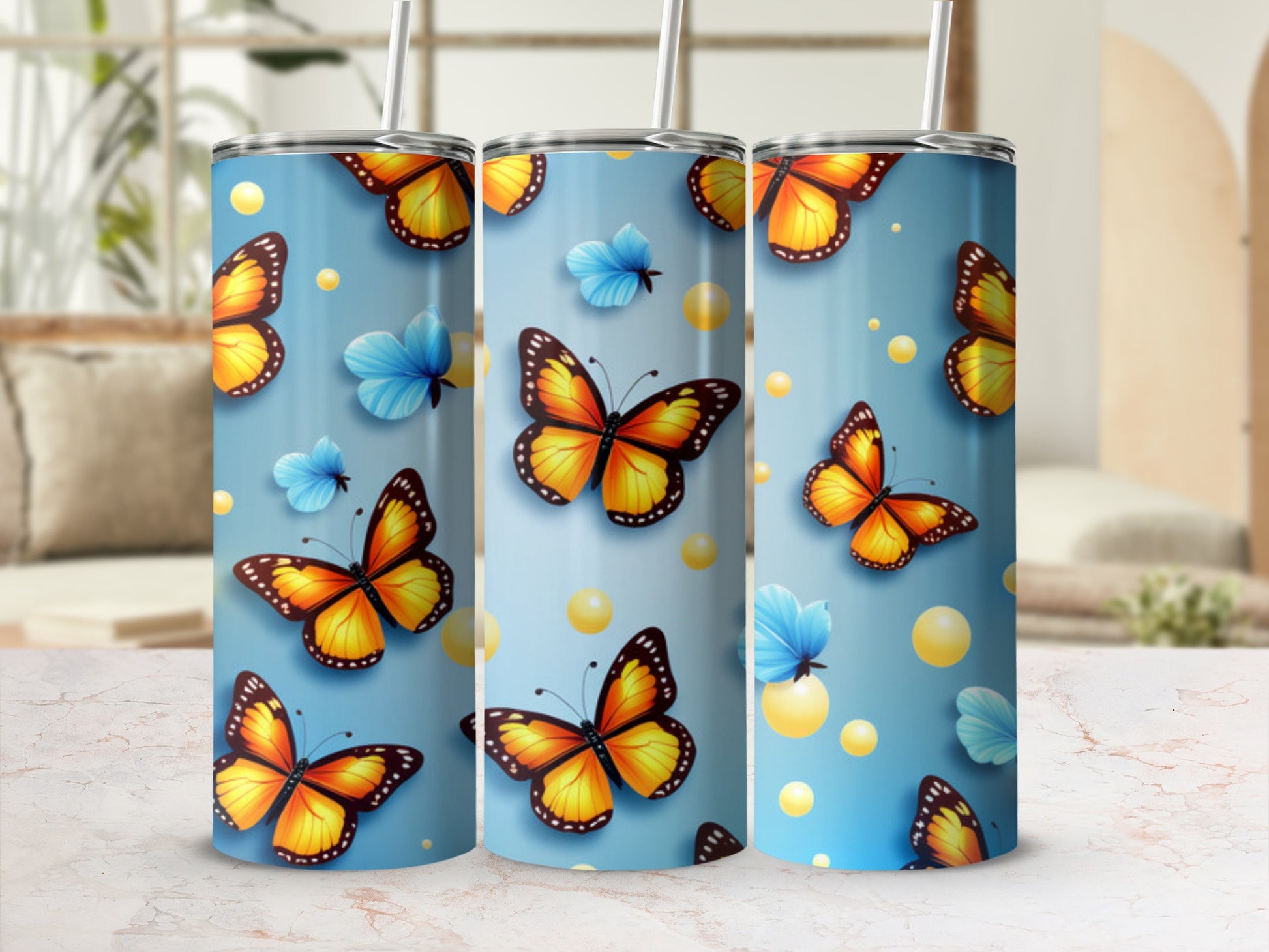 Three tall tumblers with orange butterflies and blue bubbles on a blue background.