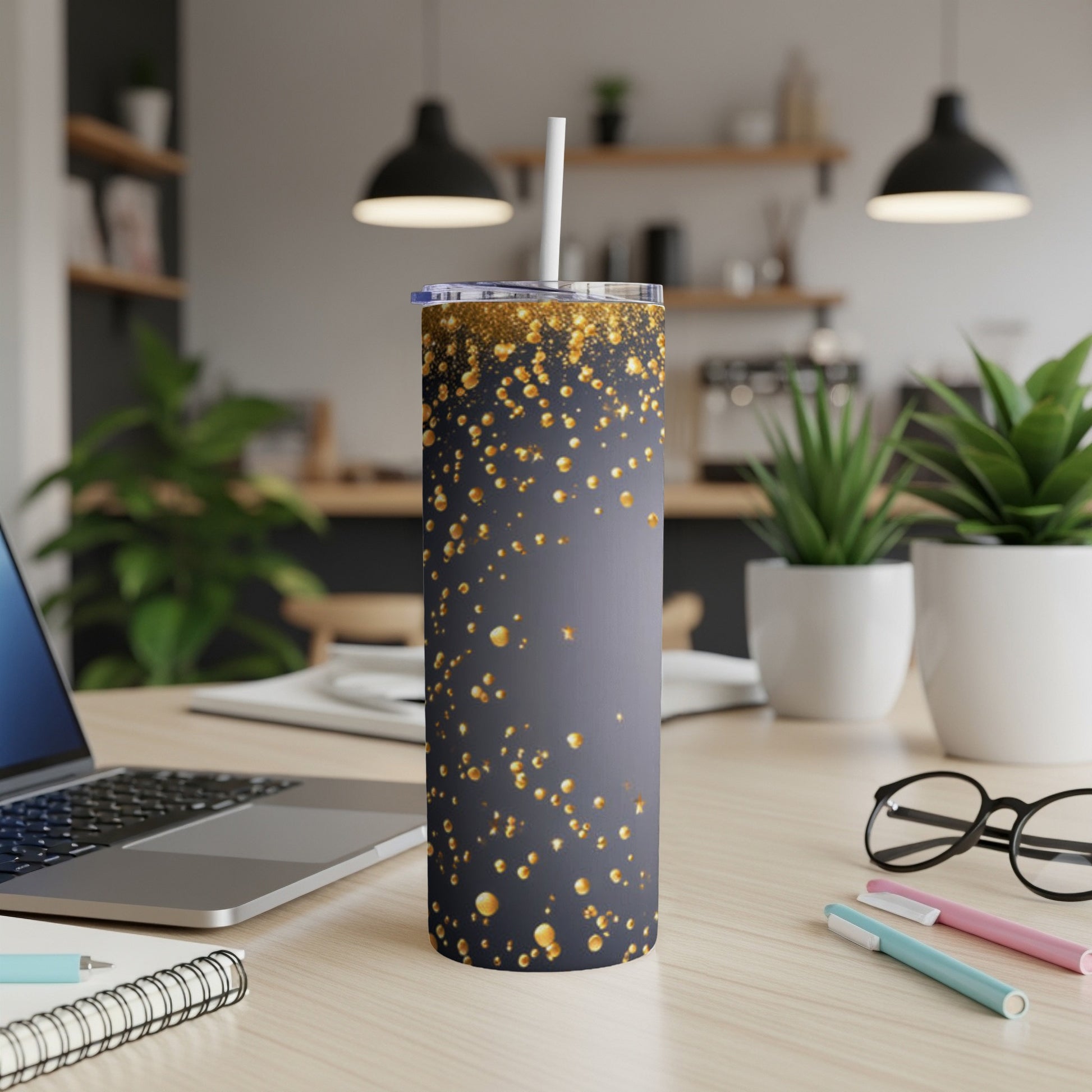 Gray tumbler with gold glitter speckles and a white straw.