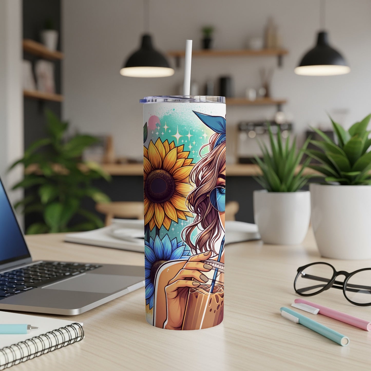 Tumbler with sunflower and woman design, holding iced coffee.