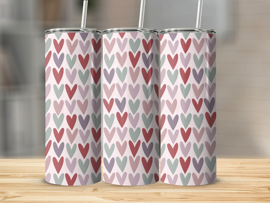 Three tall tumblers with a repeating pattern of small hearts in pink, purple, and grey.