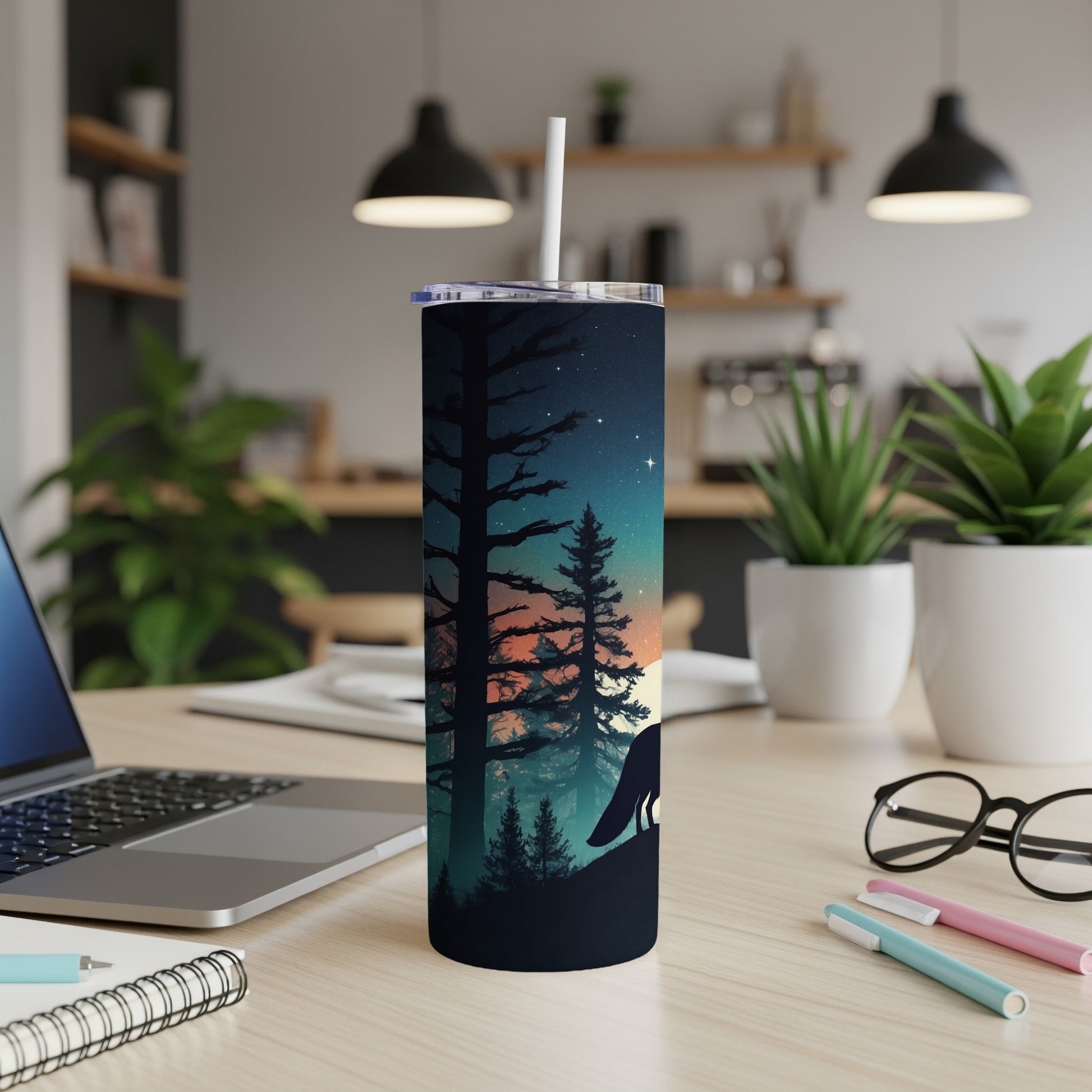 Wolf silhouette against a starry night sky and silhouetted trees on a blue tumbler.