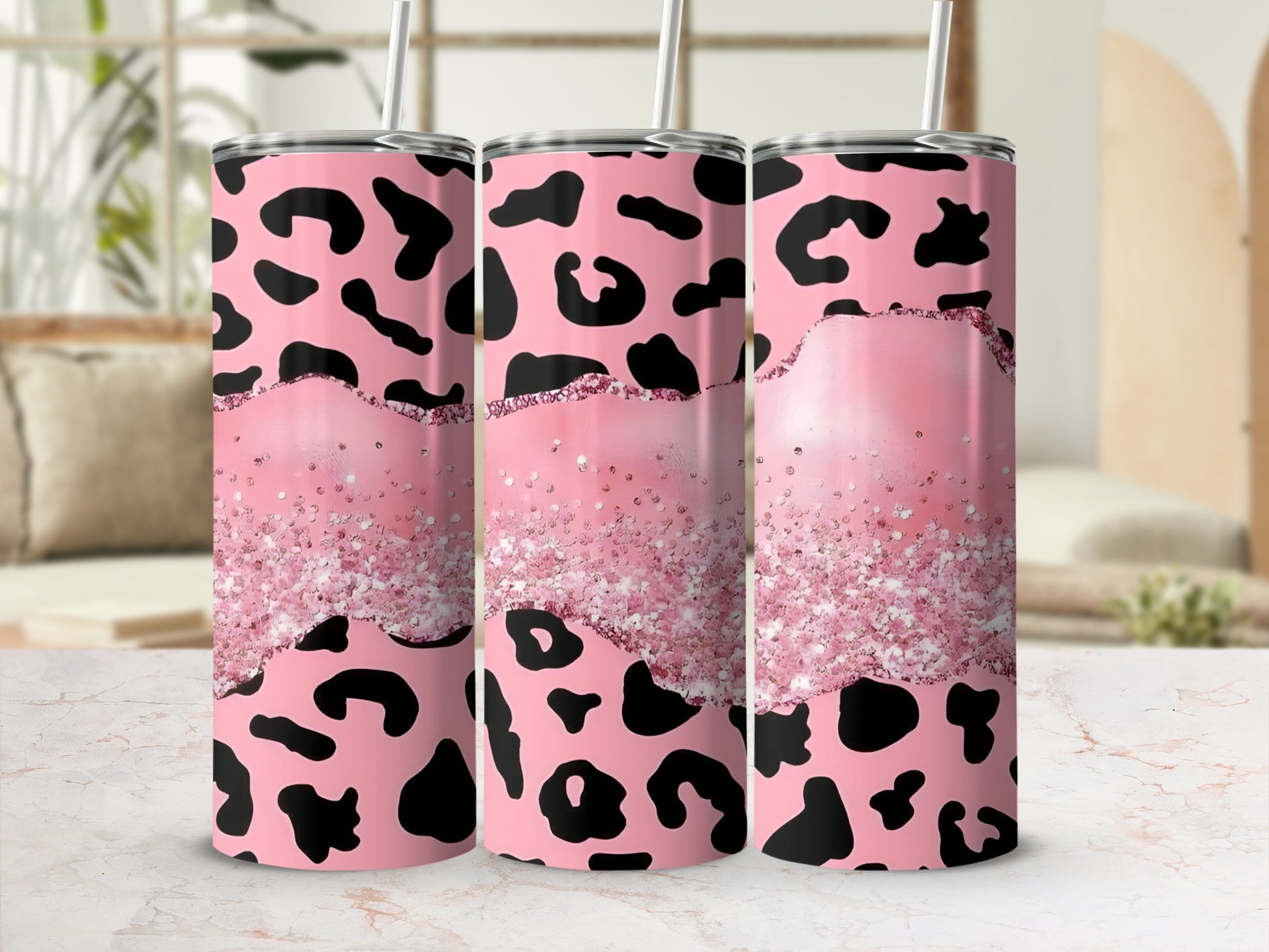Pink cheetah print tumbler with glitter band and straw.