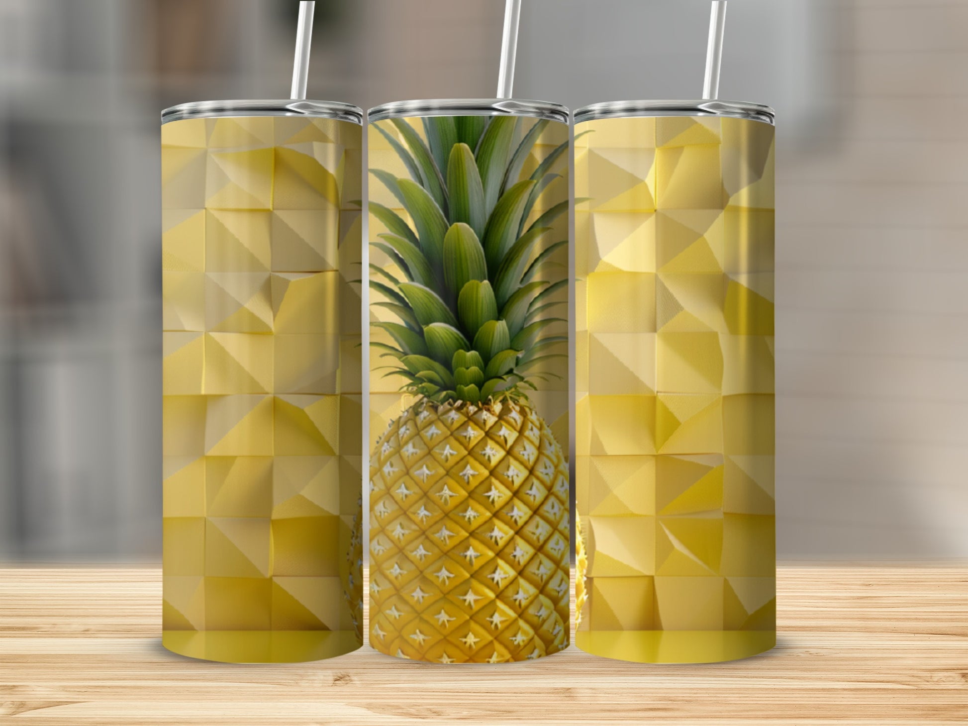 Three tumblers with a pineapple pattern on a wooden surface.