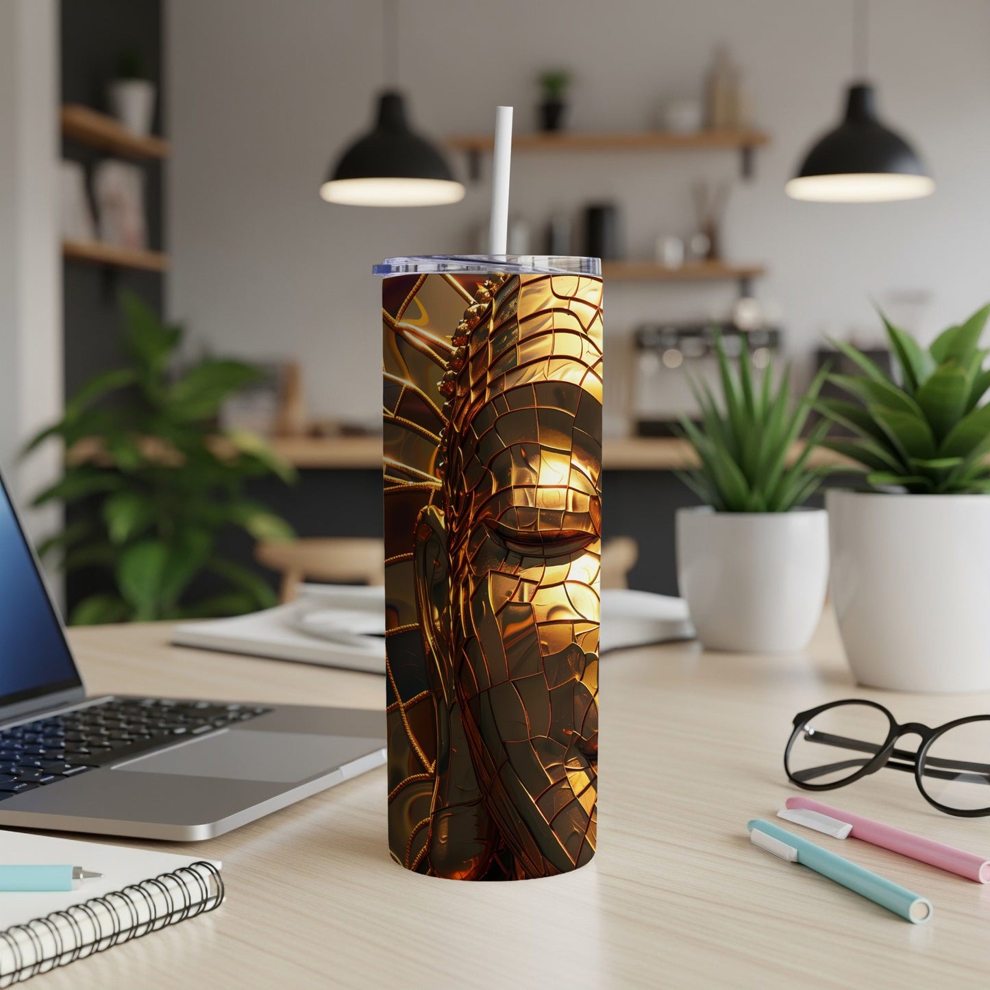 Golden metallic textured tumbler with a straw on a desk.