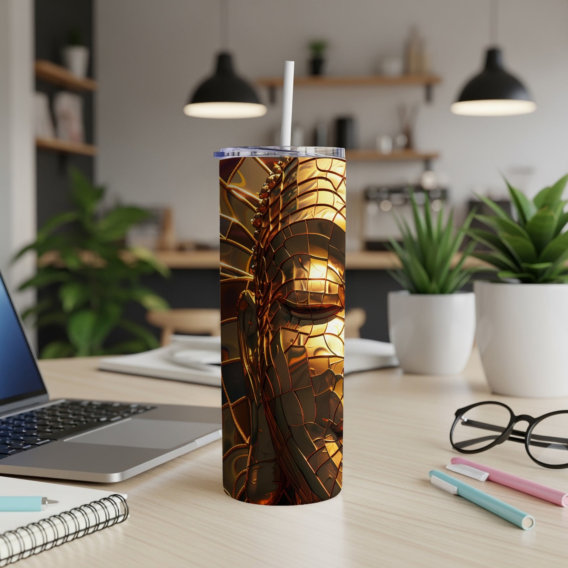 Golden metallic textured tumbler with a straw on a desk.