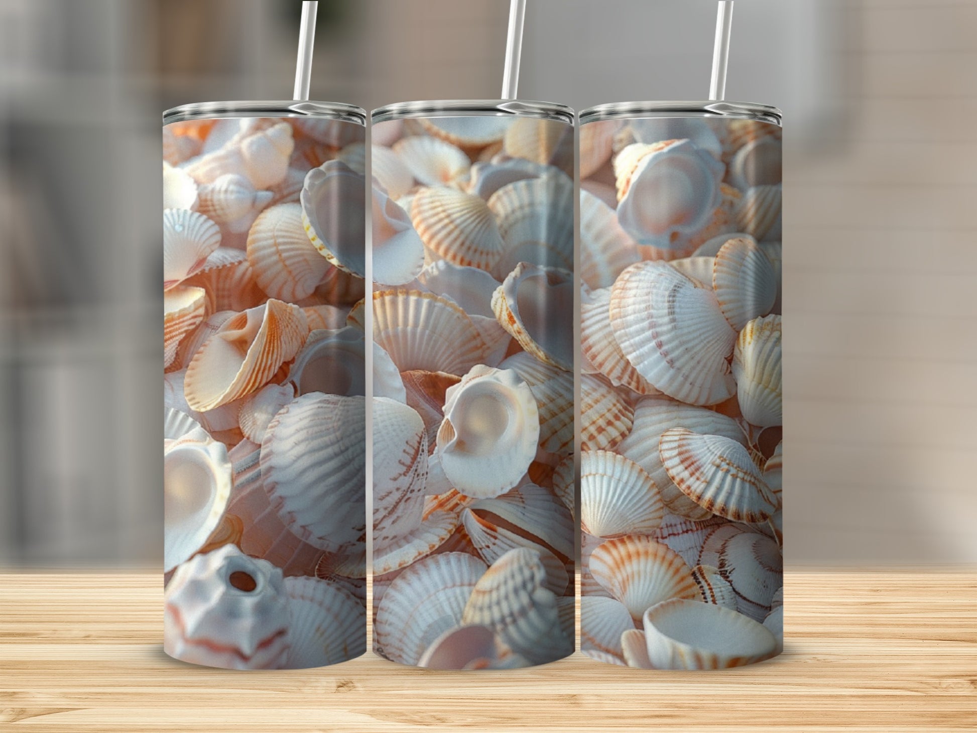 Three tumblers with a close-up of seashells on a wooden surface.