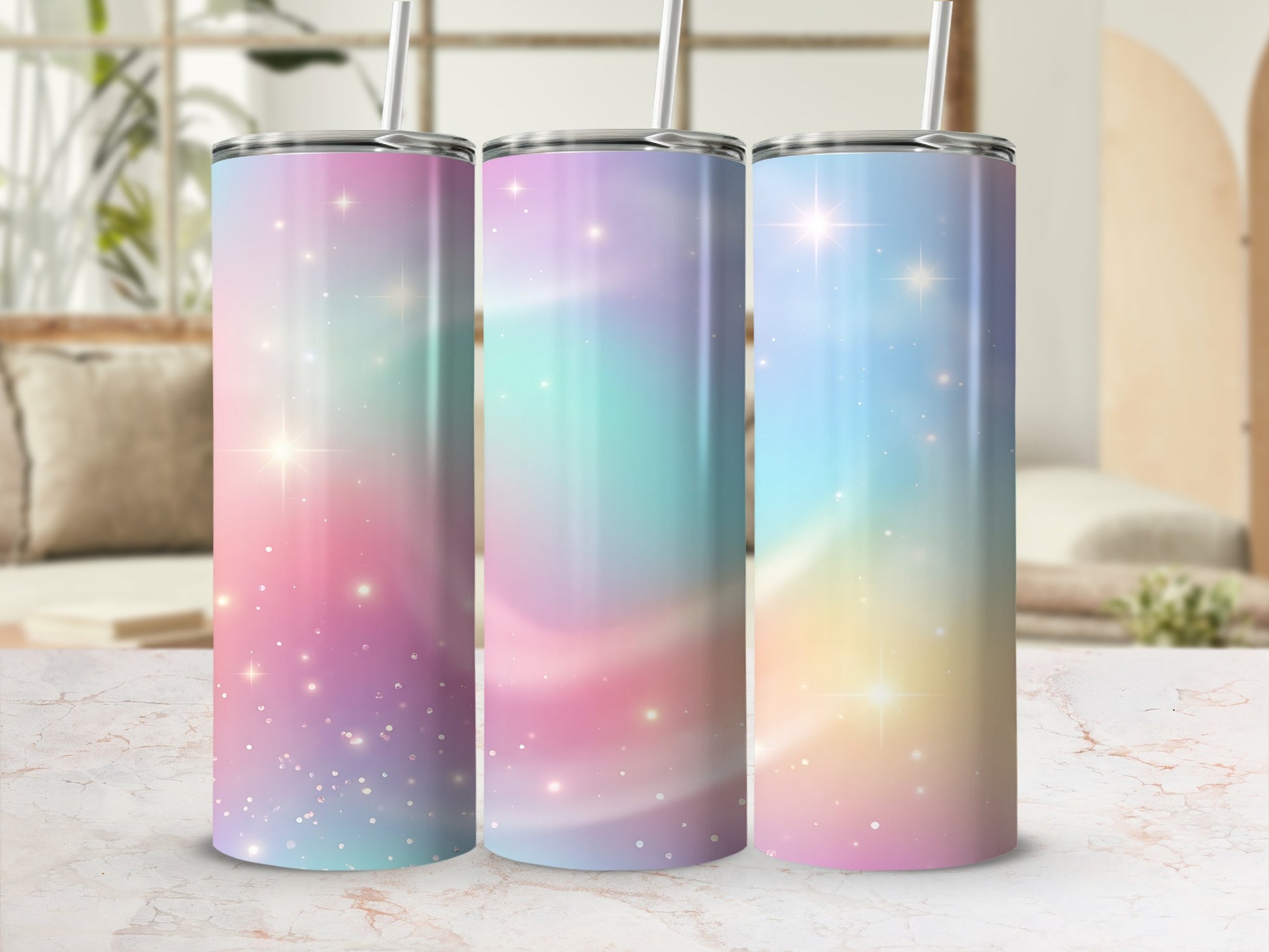 Three tumblers with pastel galaxy designs and sparkling stars.