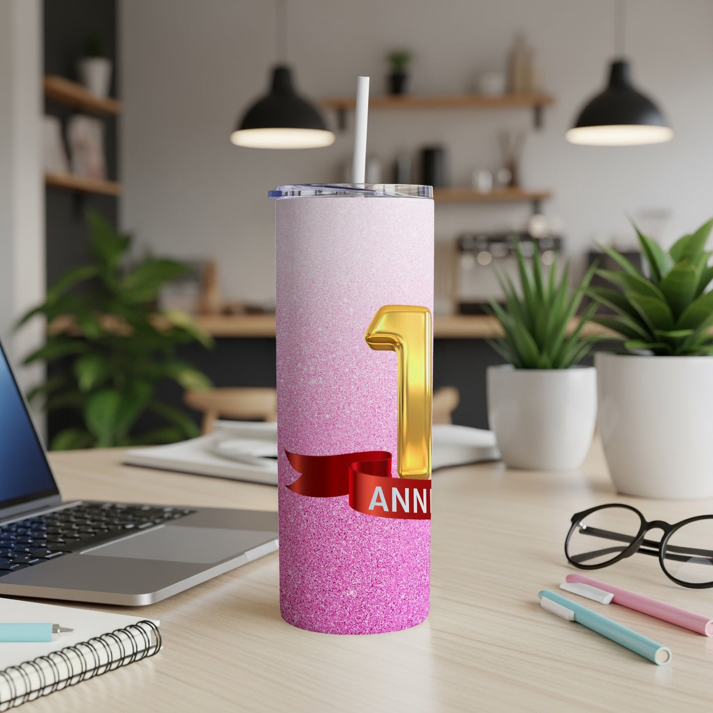 Pink glitter tumbler with "1 ANNIVERSARY" text and a red ribbon.