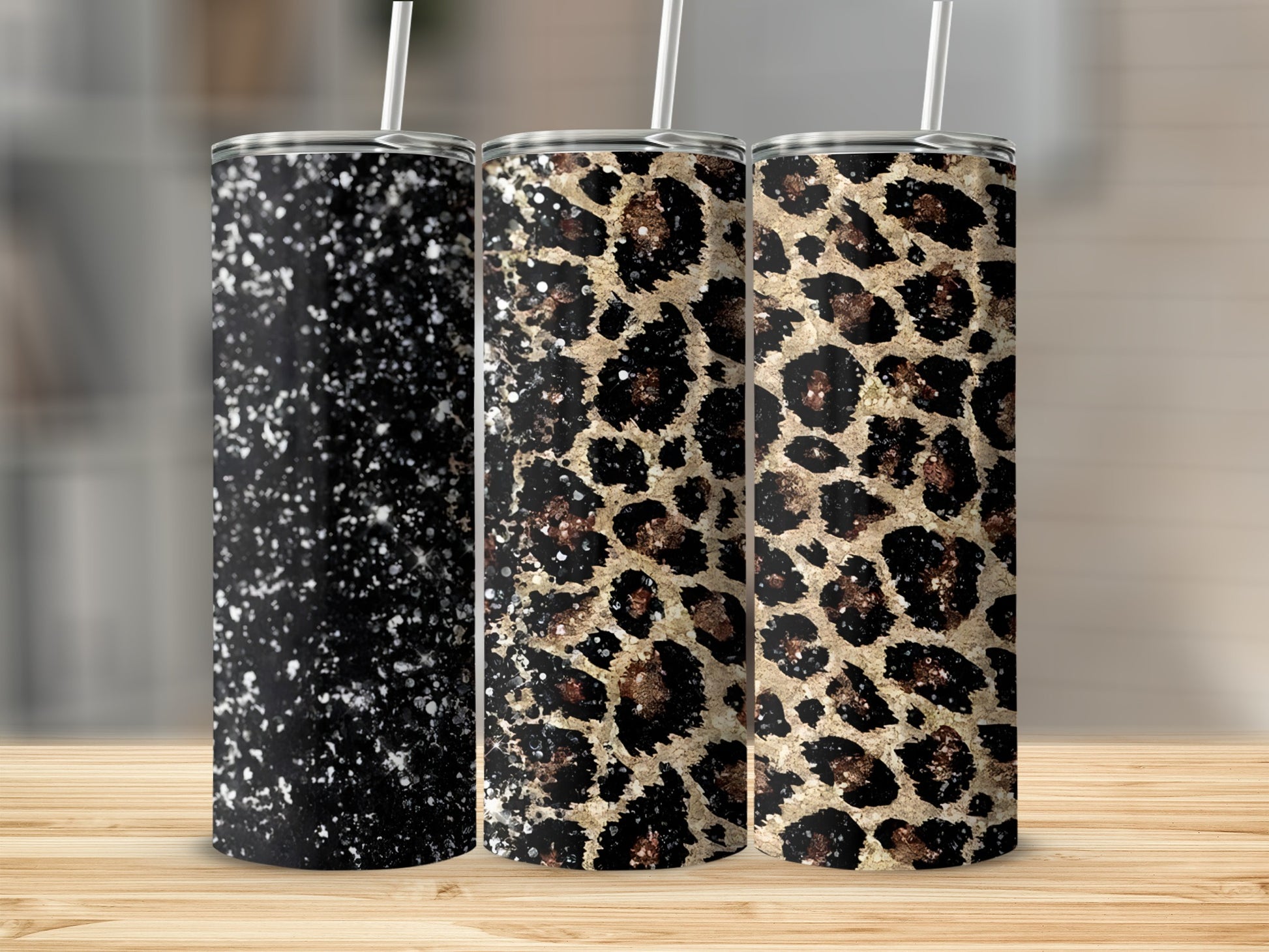 Three tumblers with speckled black, leopard print, and glitter designs.