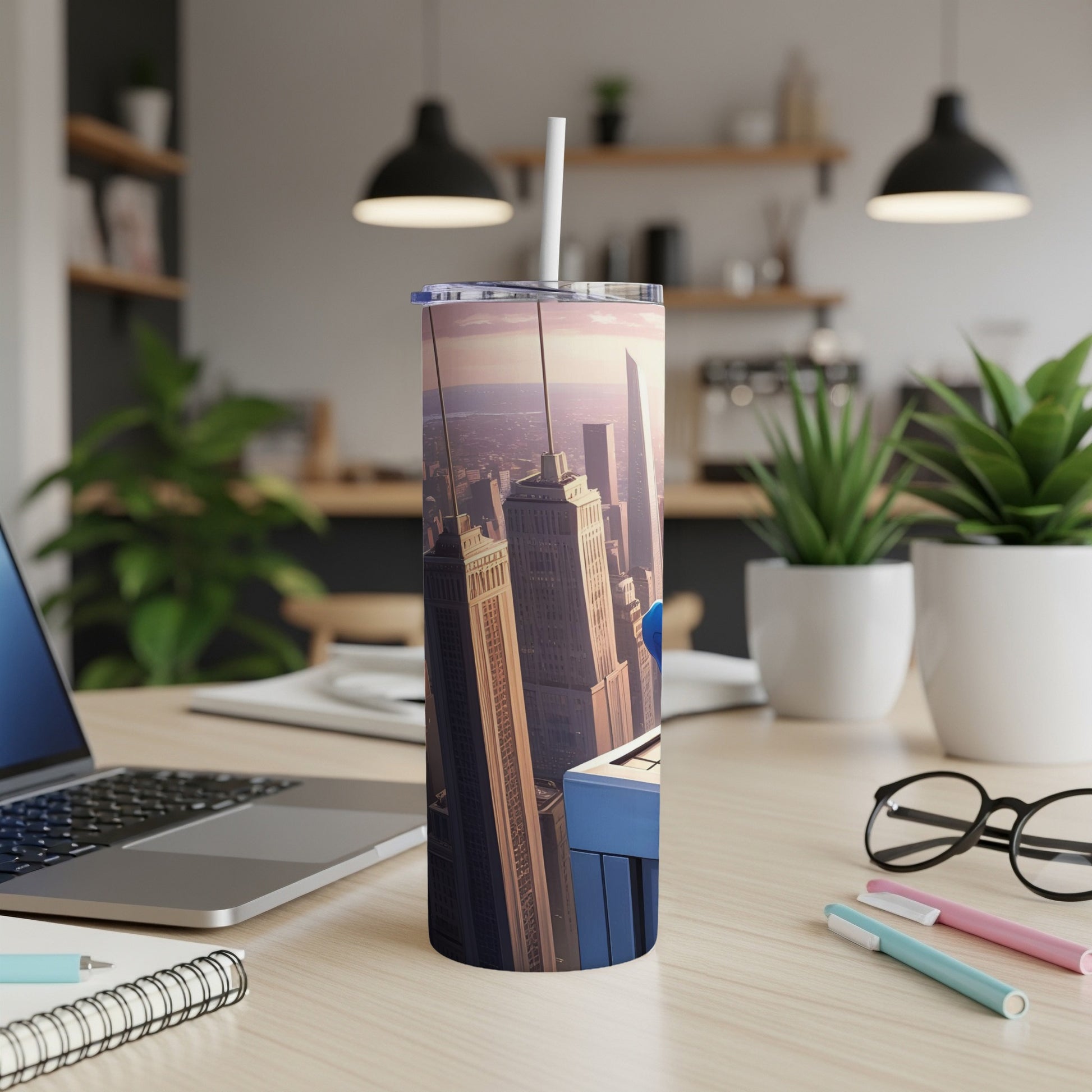 Tumbler with city skyline and keyboard design on desk.