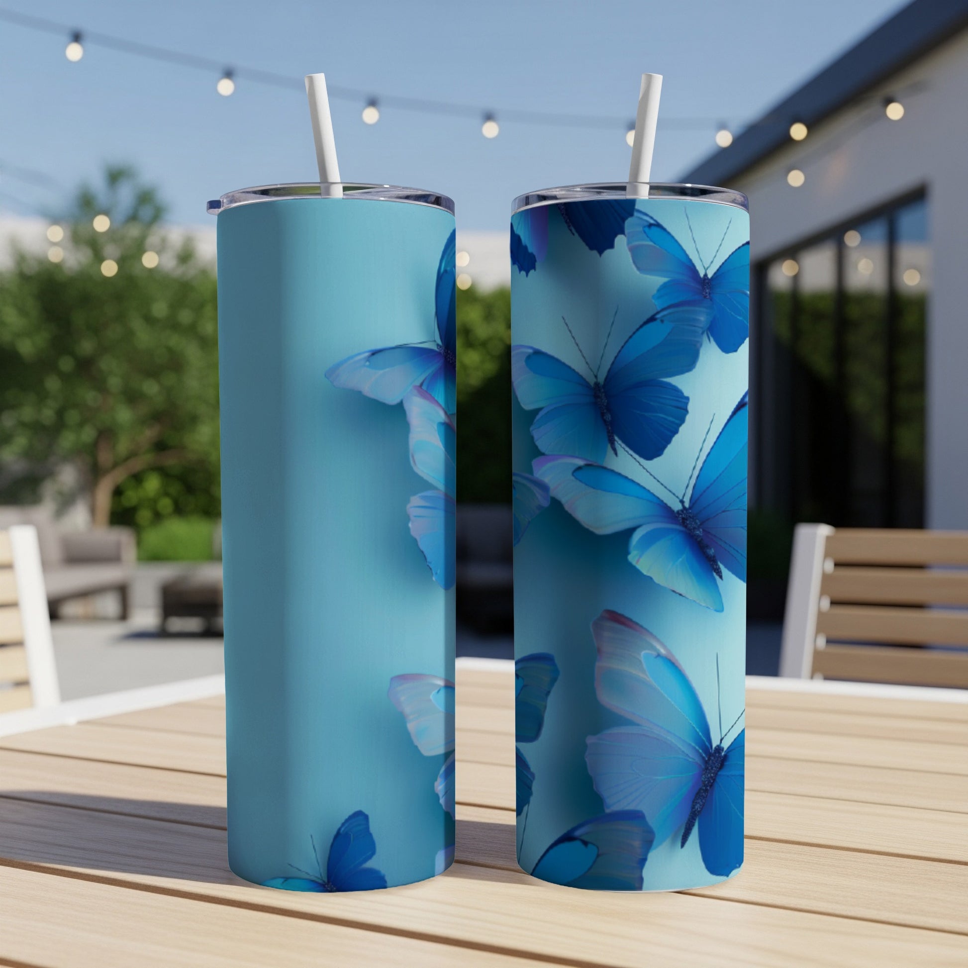 Two blue tumblers with a vibrant blue butterfly pattern.