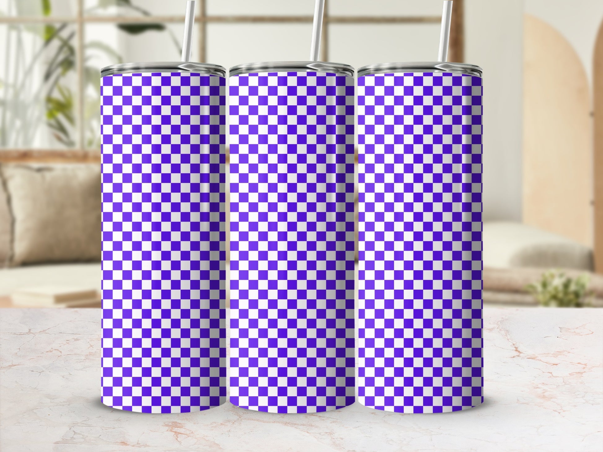 Three purple and white checkered pattern tumblers with straws.