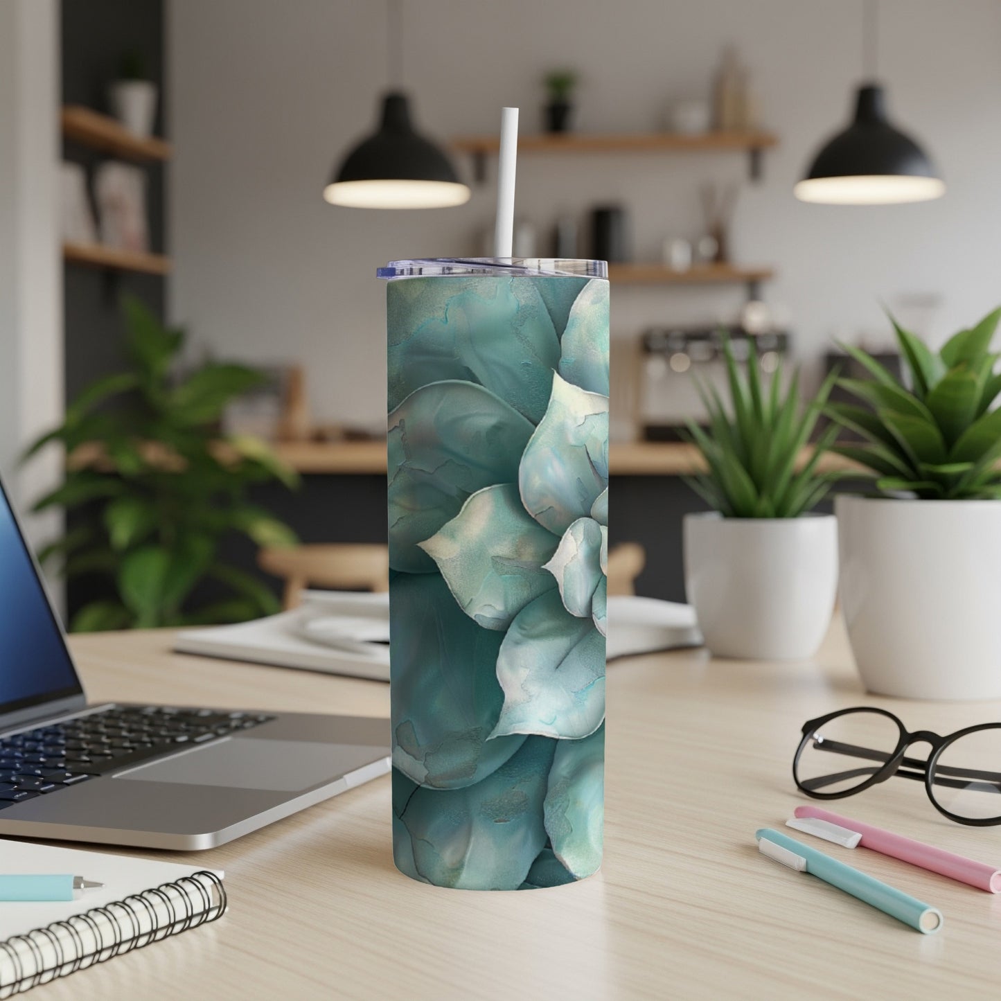 Green succulent pattern on a white tumbler with a straw.