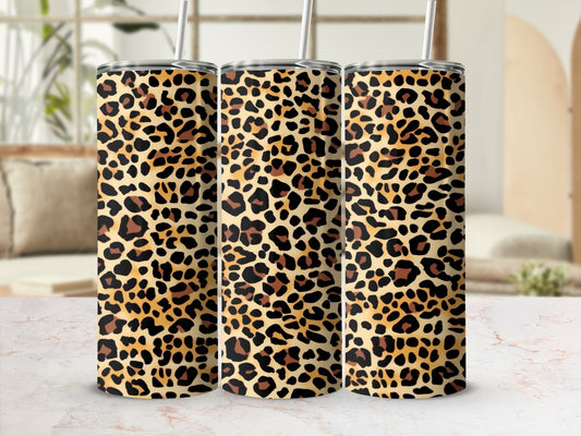 Three tumblers with a leopard print design and metal straws.