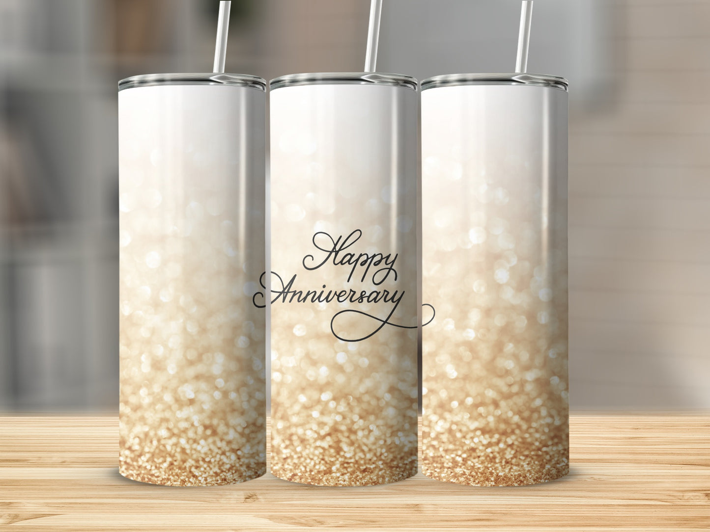 Three tall, skinny tumblers with a gradient of gold glitter and "Happy Anniversary" text.