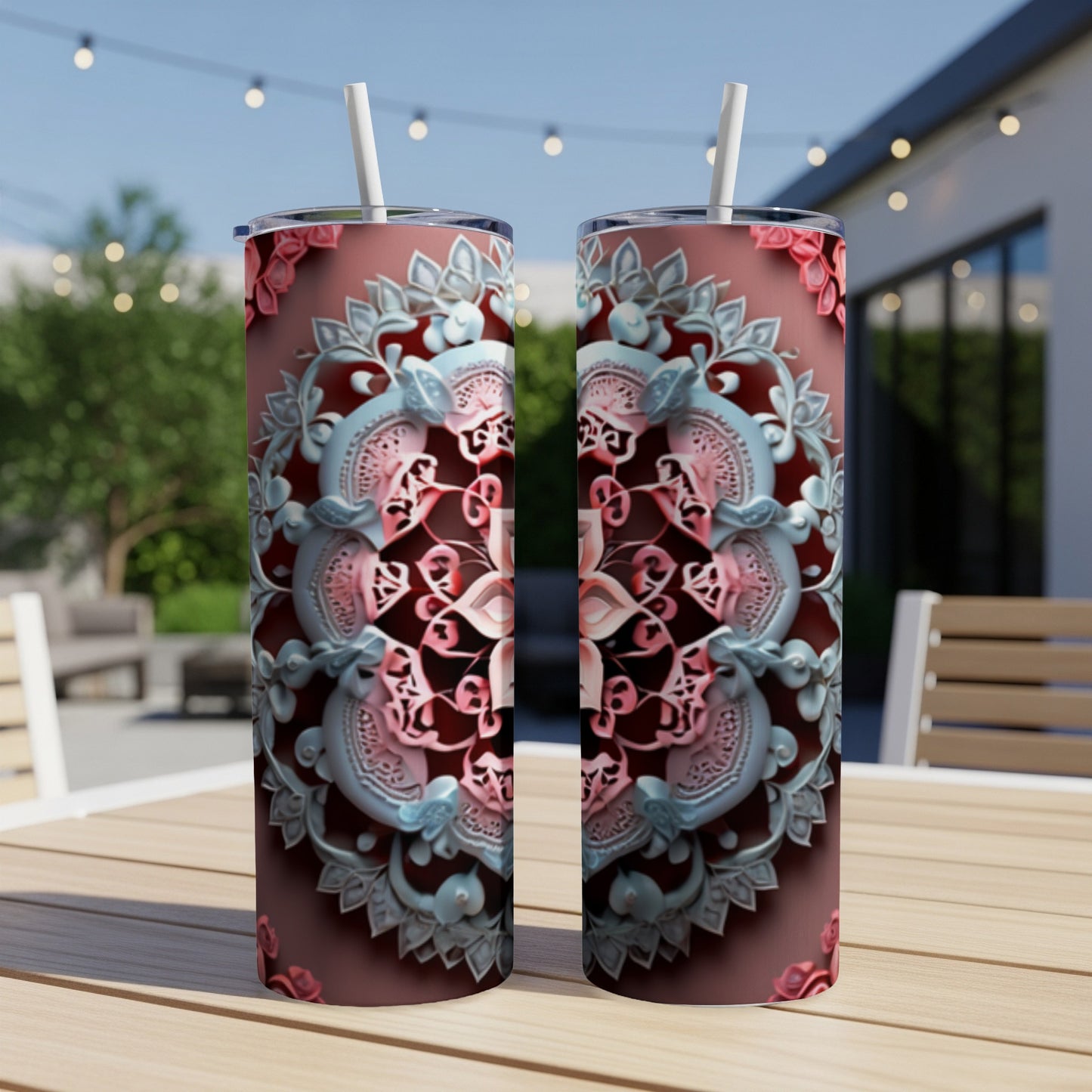Two tall tumblers with ornate pink and blue mandala designs sit on a wooden table.