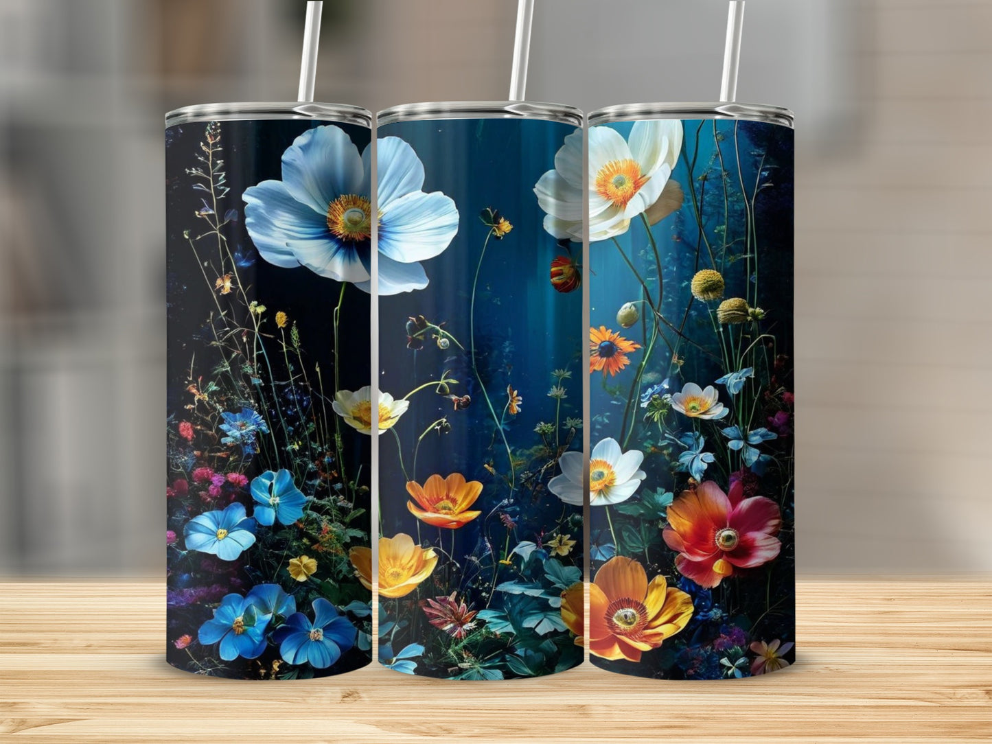 Three tumblers featuring colorful wildflowers on a dark, moody background.