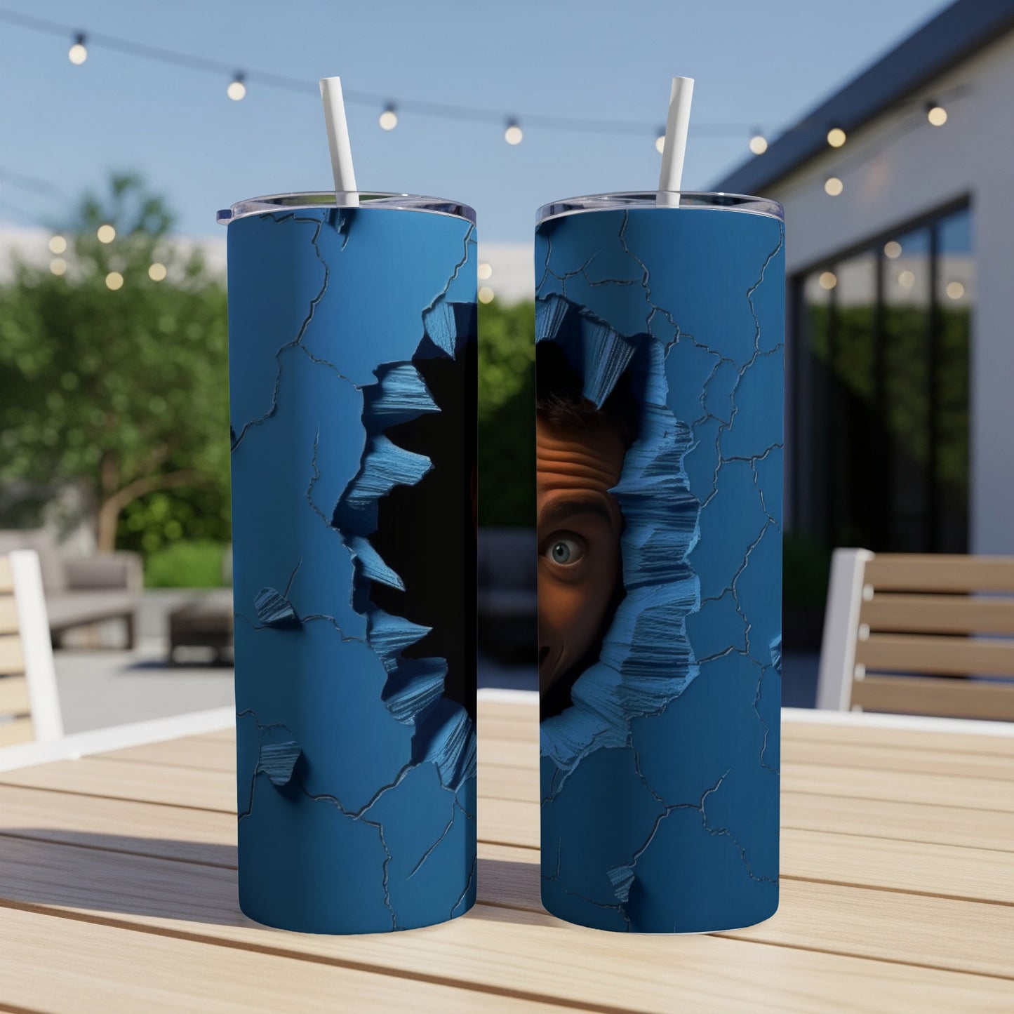 Two blue tumblers with a cracked design and a peeking eye graphic.