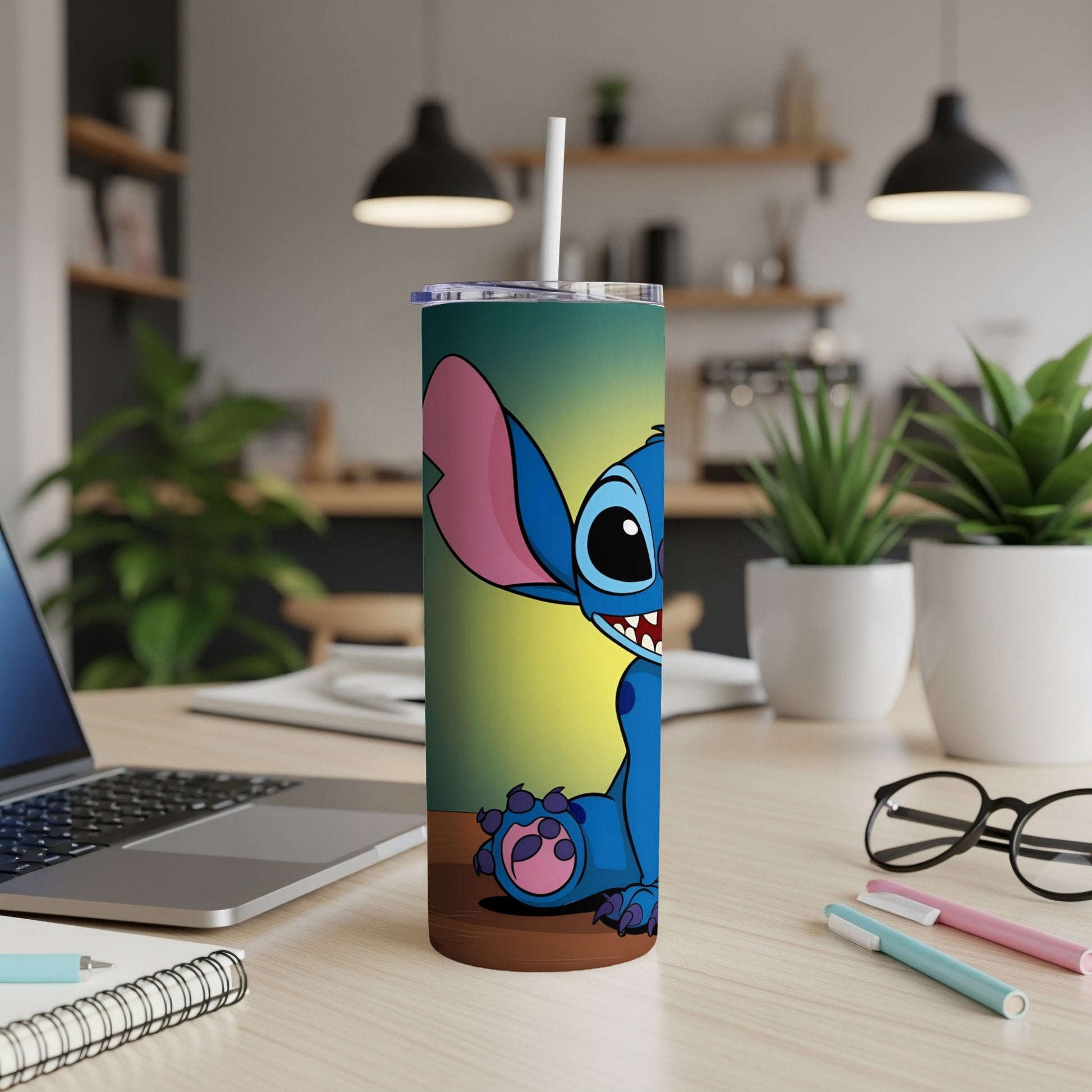 Blue Stitch character on a colorful tumbler with a straw.