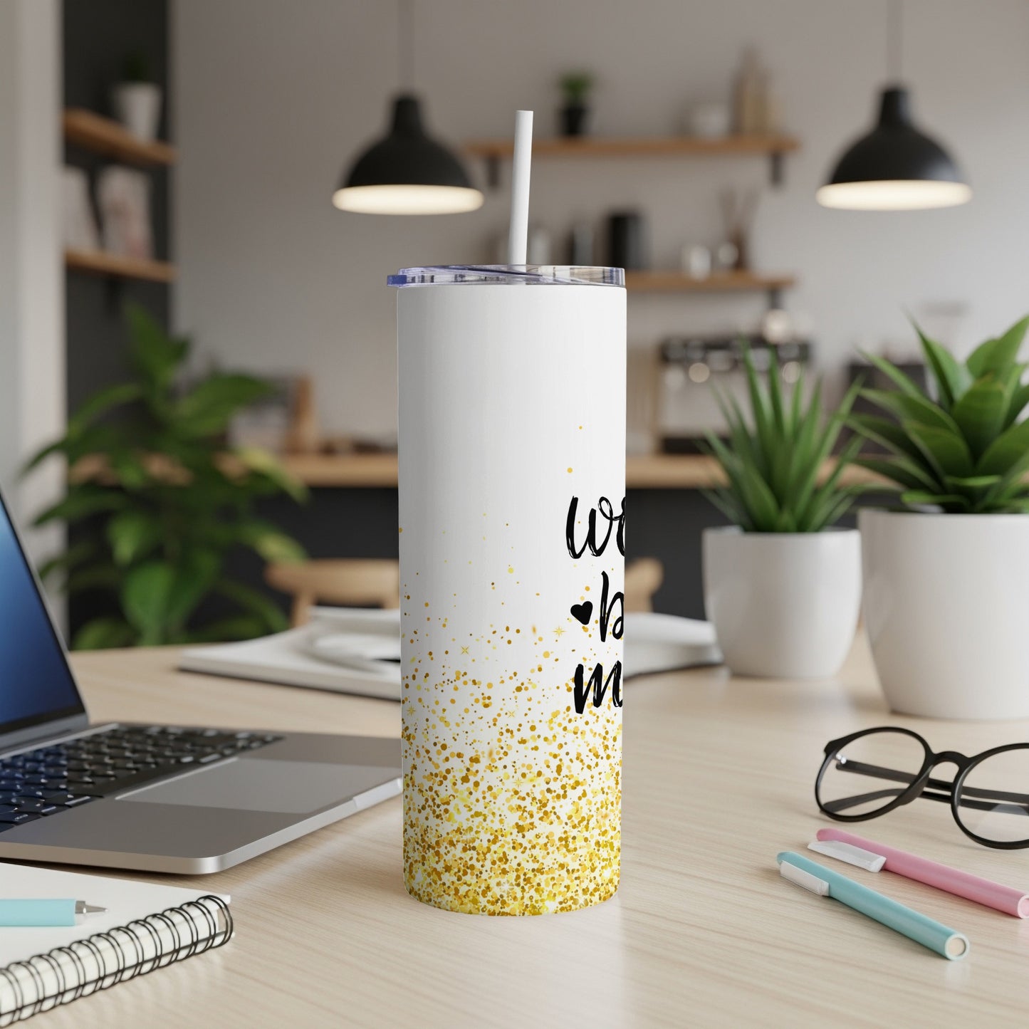 White tumbler with gold glitter and "works by mom" text.