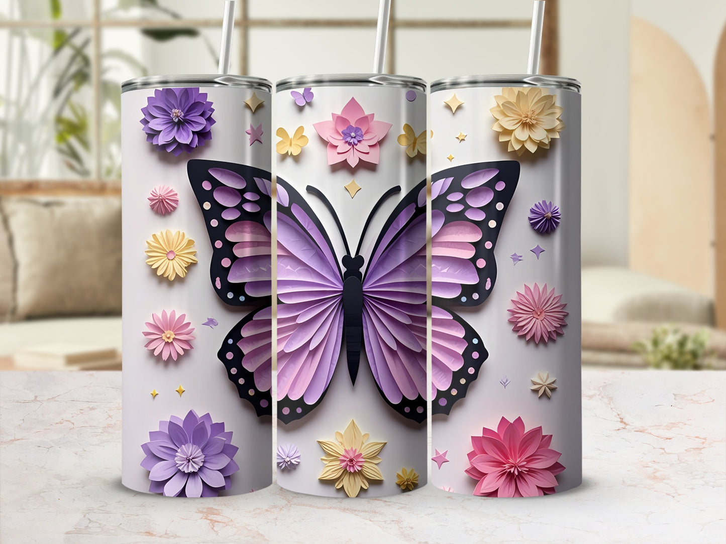 Three tumblers decorated with purple and pink butterflies and floral paper art.