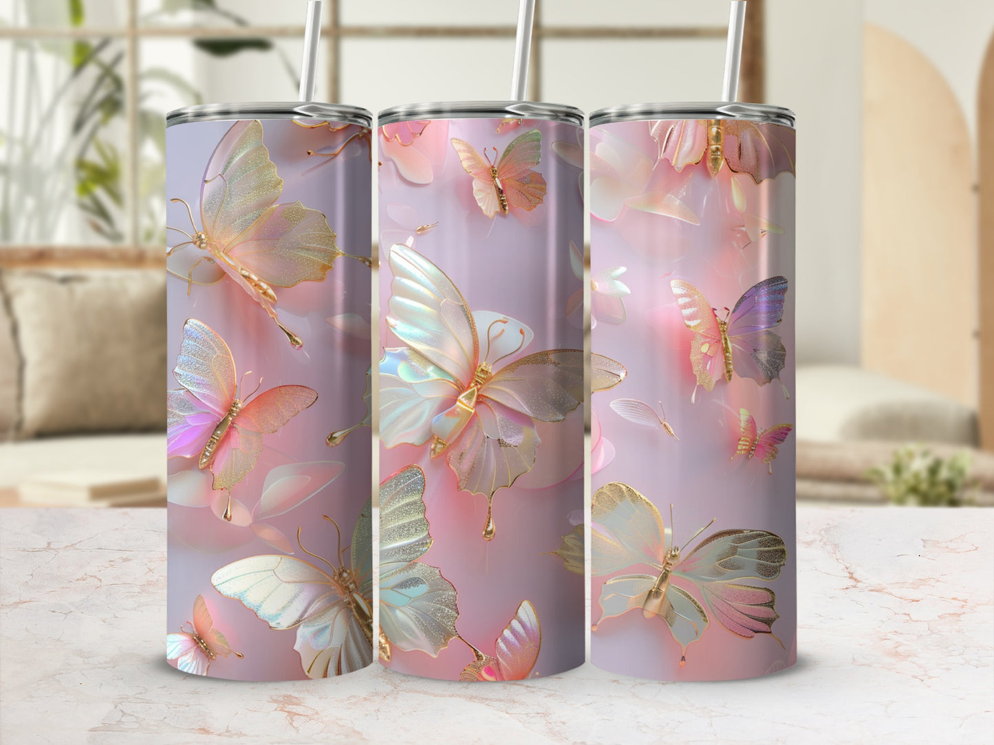 Three tumblers with pastel butterfly and floral designs on a marble surface.