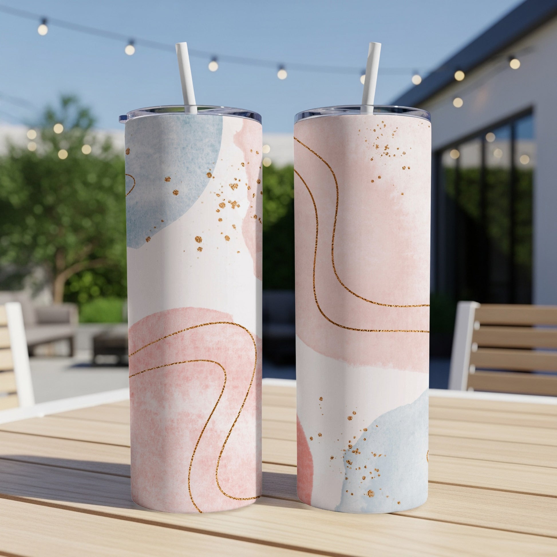 Two tall tumblers with abstract pastel watercolor and gold line art designs.