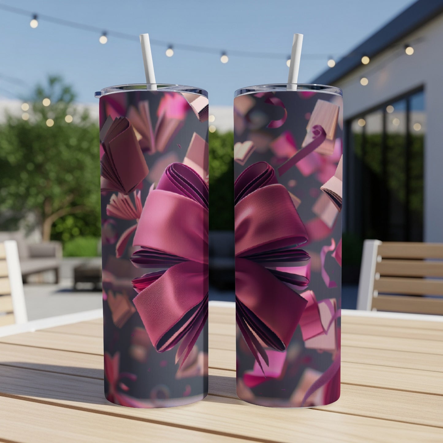 Two tumblers with a large pink bow and flying open books design.