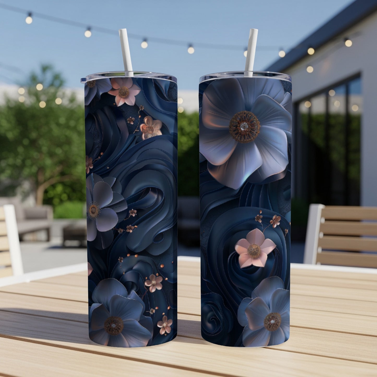 Two tumblers with dark floral and swirl designs sit on a wooden table.