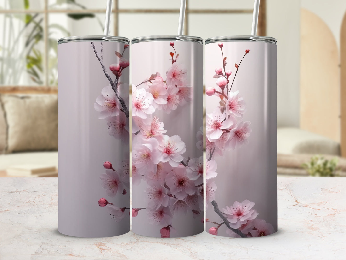 Three skinny tumblers with a pale pink cherry blossom design.