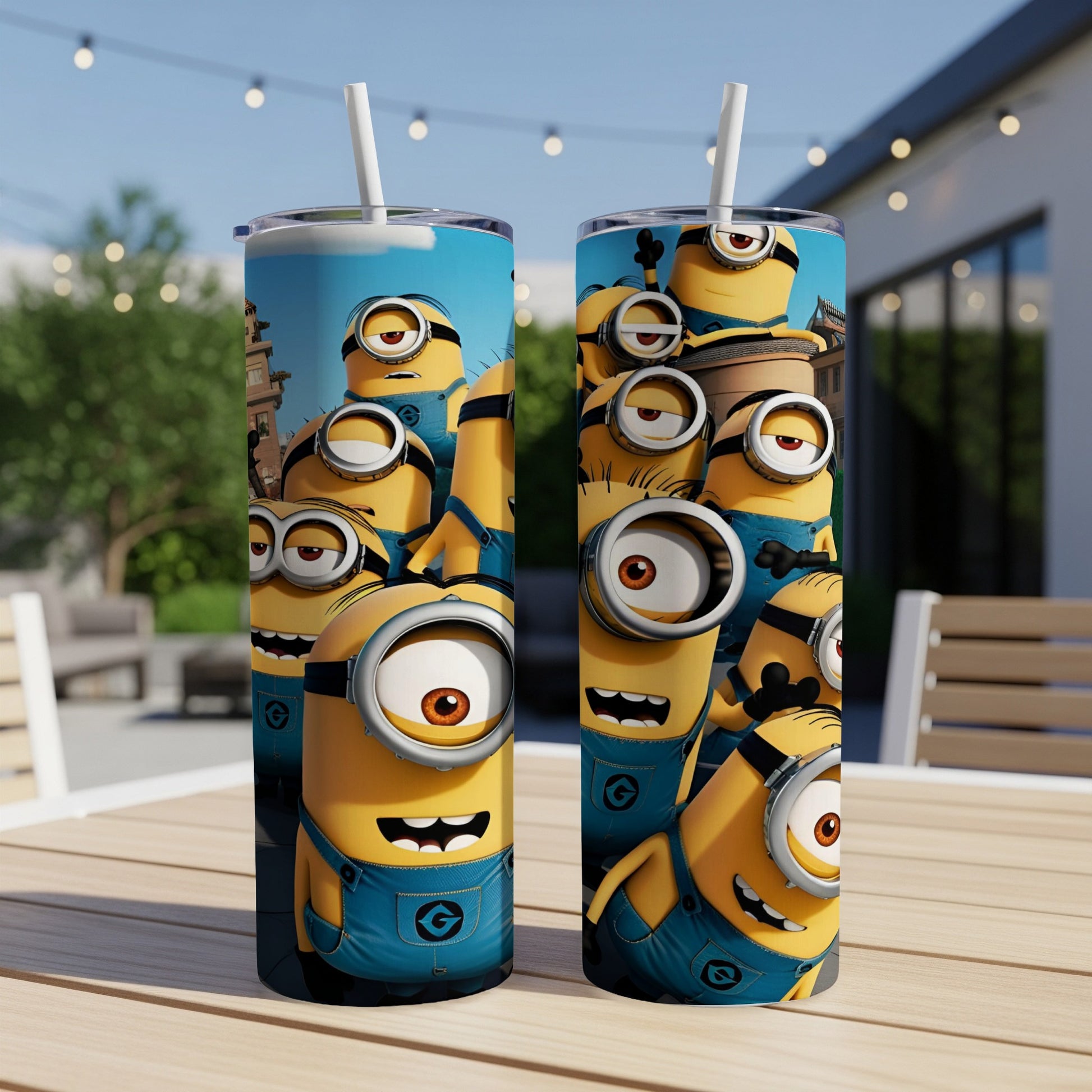 Two Minions-themed tumblers with straw on a table, outdoor background.