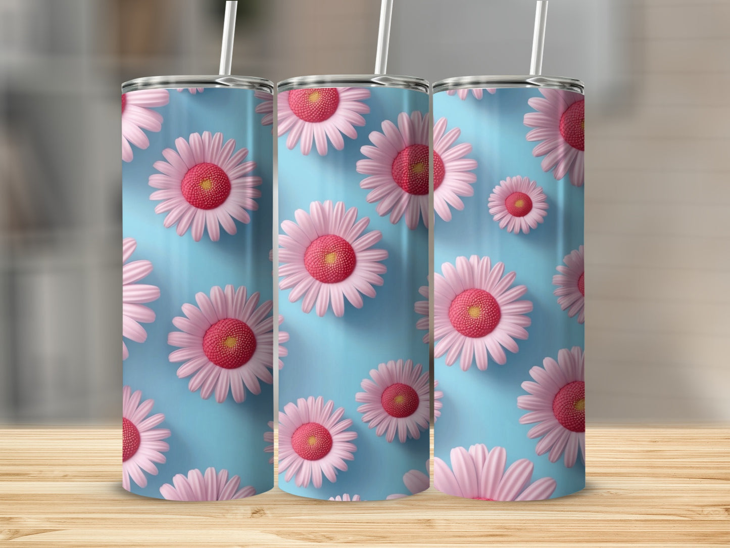 Three tumblers with pink daisies on a light blue background.