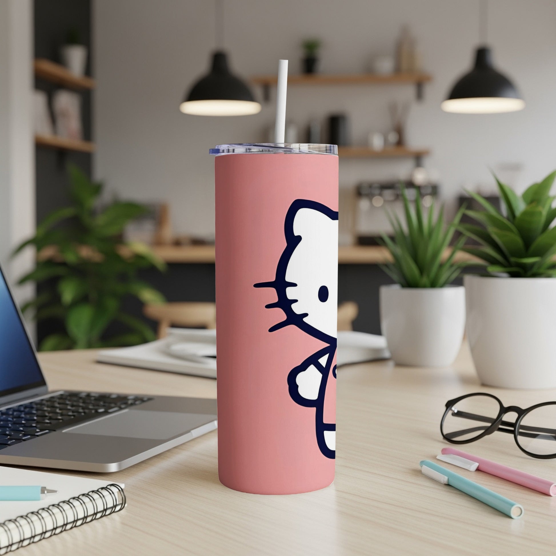 Pink Hello Kitty tumbler with white straw on a desk.