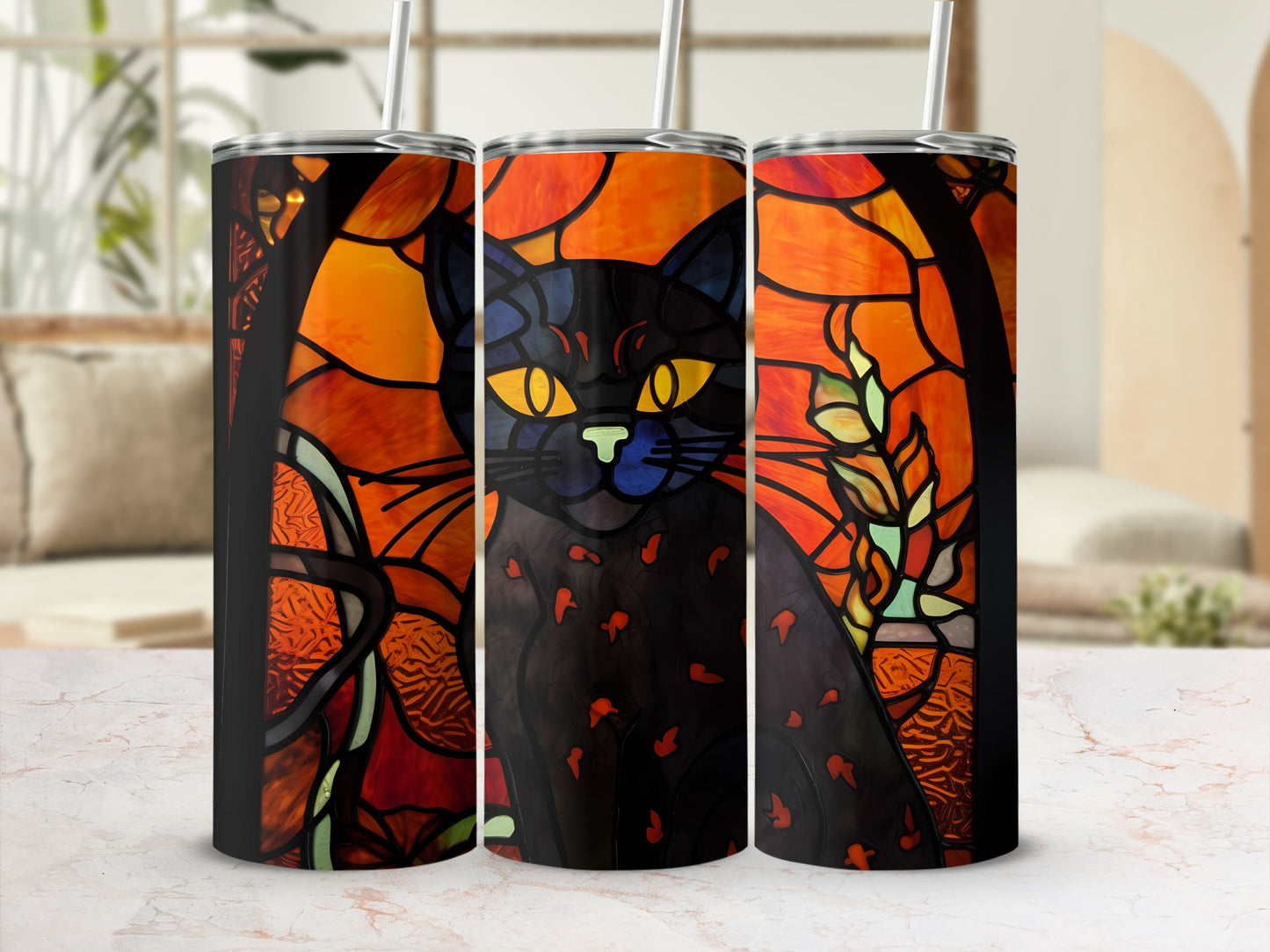 Stained glass black cat art on three tumblers against a blurred background.