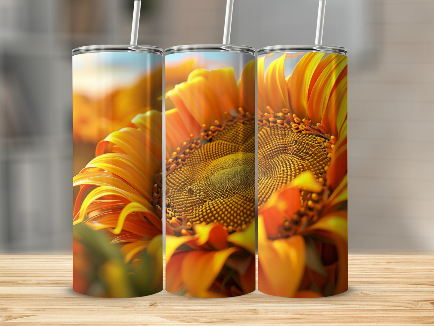 Three tumblers with close-up sunflower art on a wooden surface.