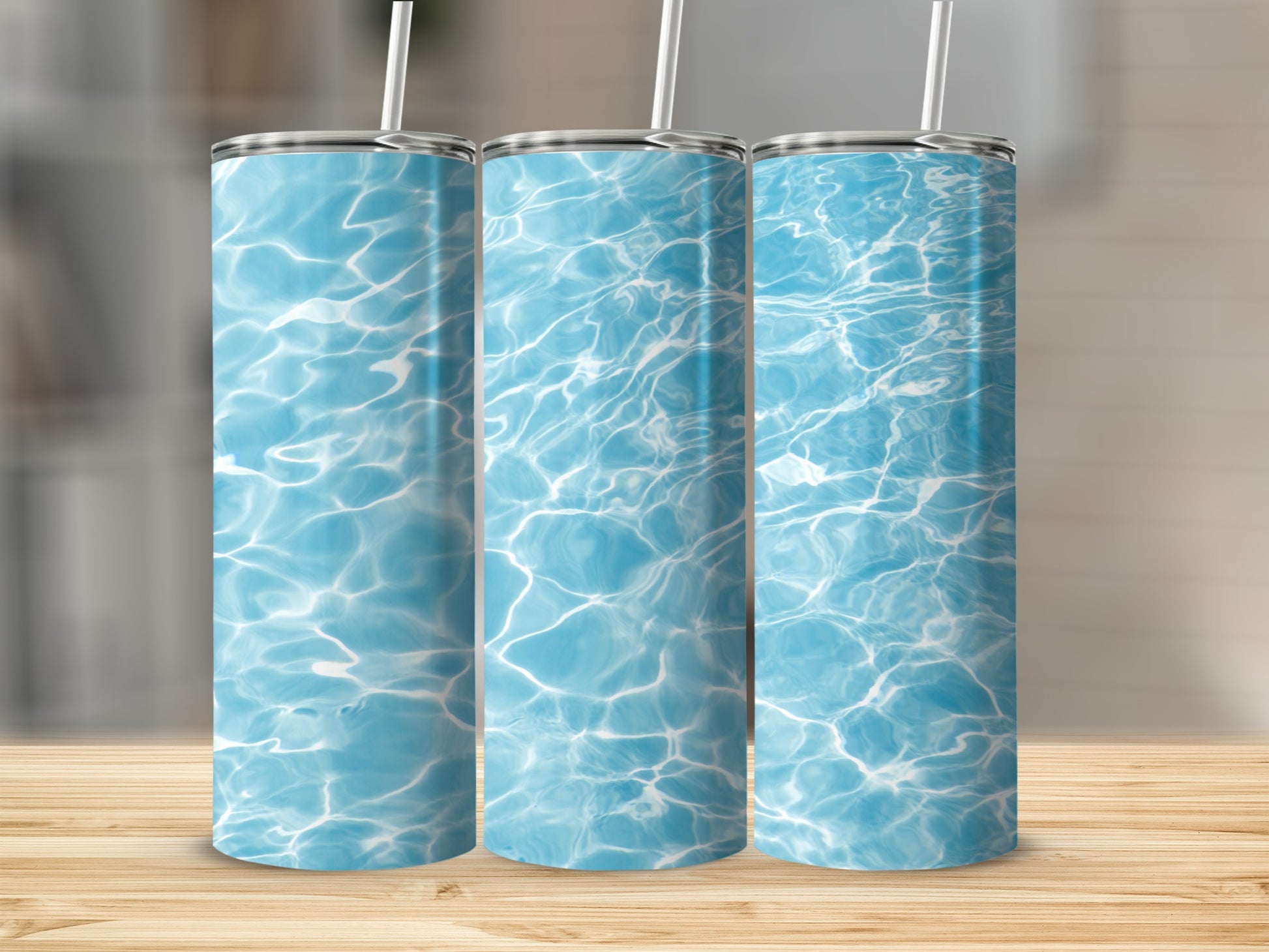 Three tumblers with a bright blue water ripple pattern.