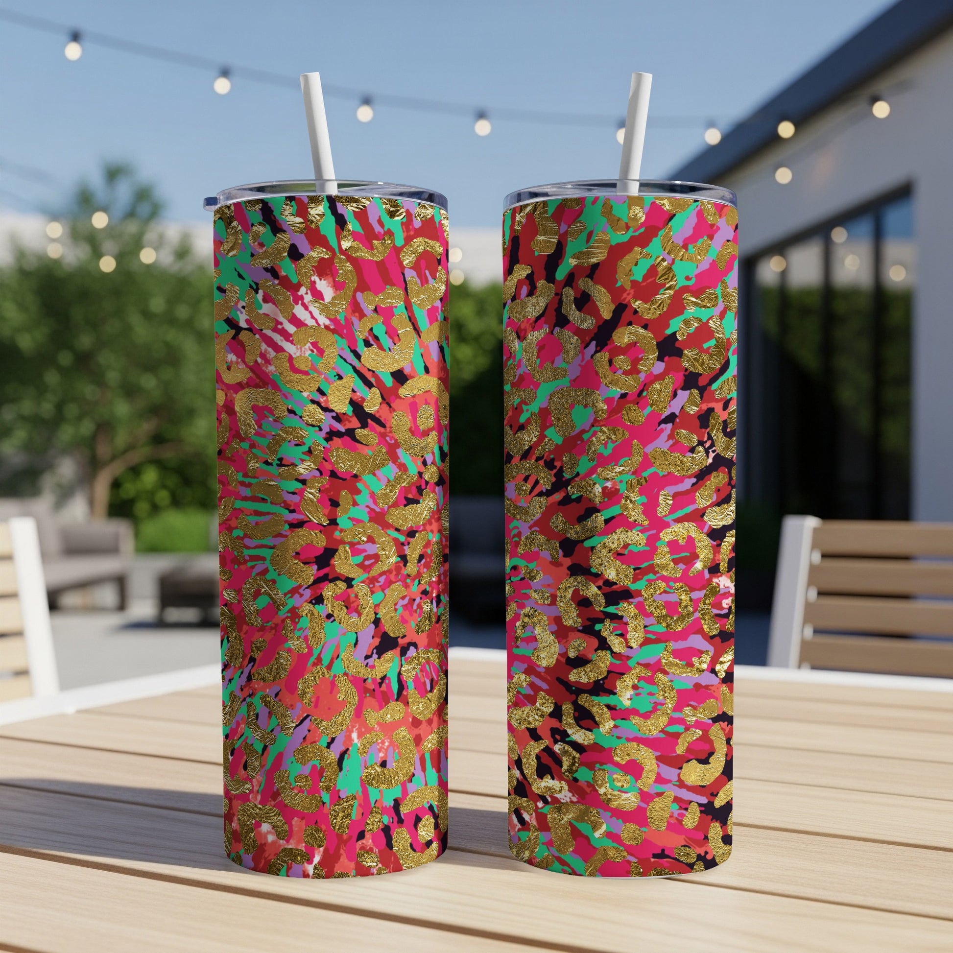 Two tumblers with gold leopard print on a multicolored abstract background.