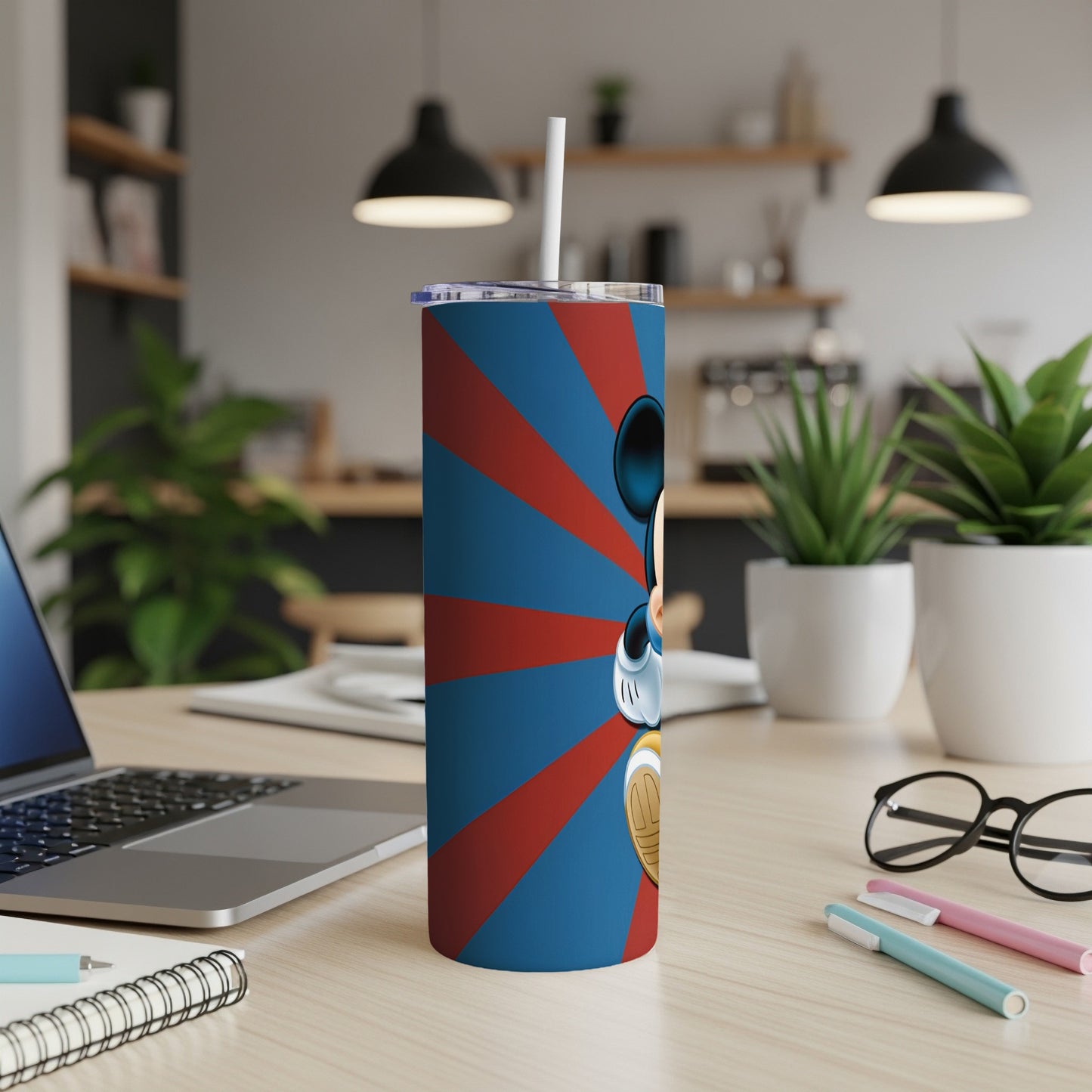 Mickey Mouse on a blue and red striped tumbler with a white straw.