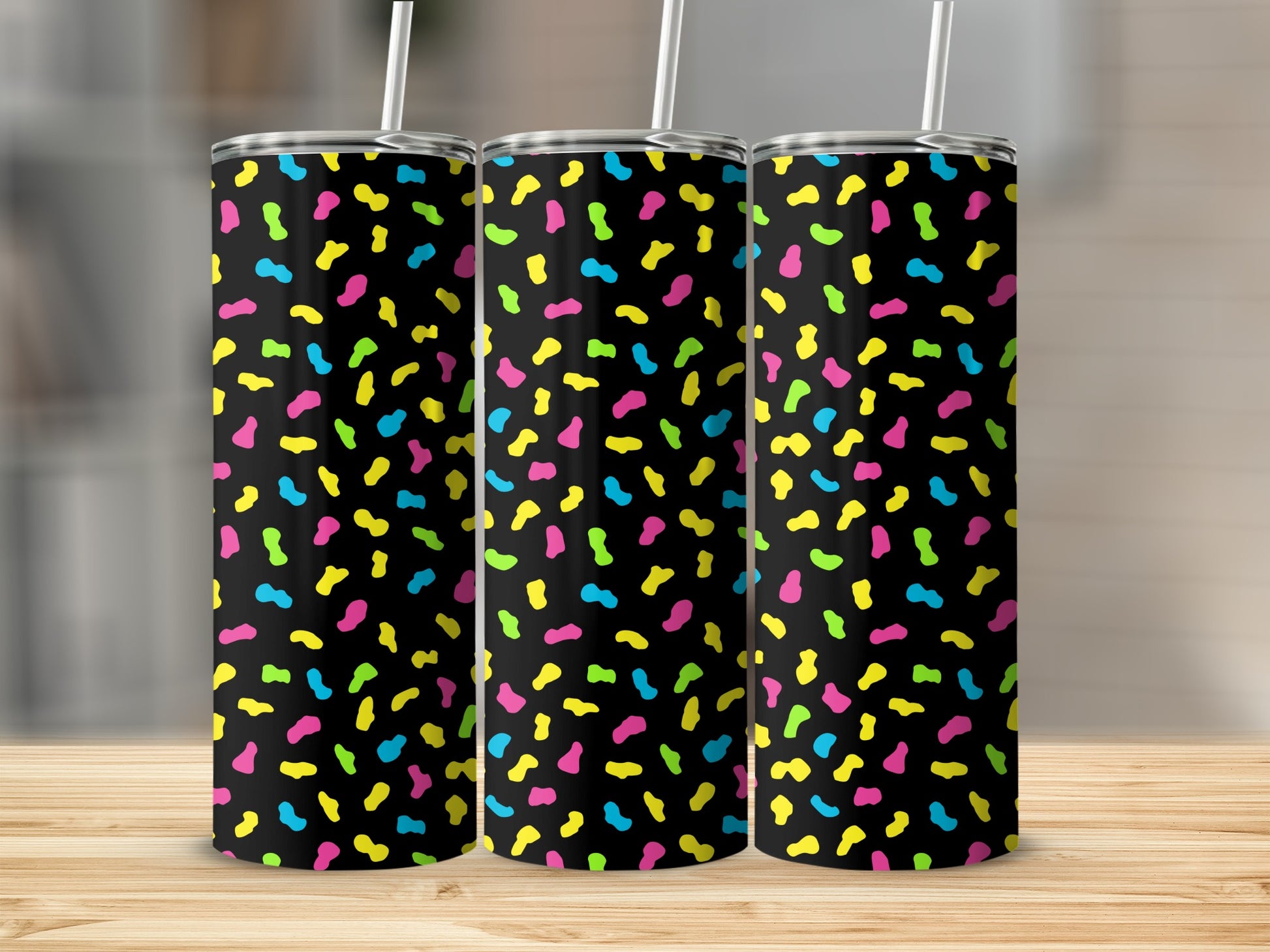 Three tumblers with a black background and colorful confetti pattern