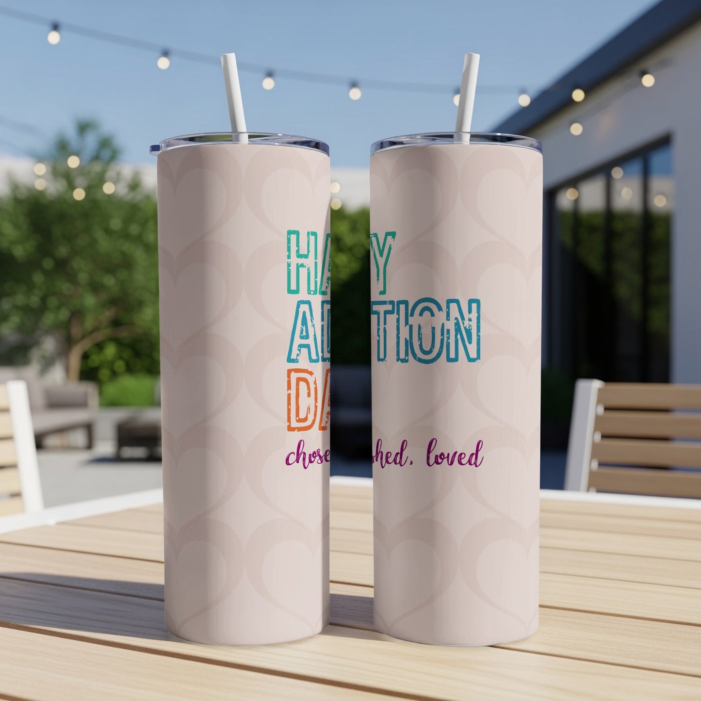 "Happy Adoption Day" text on two insulated tumblers with heart pattern.
