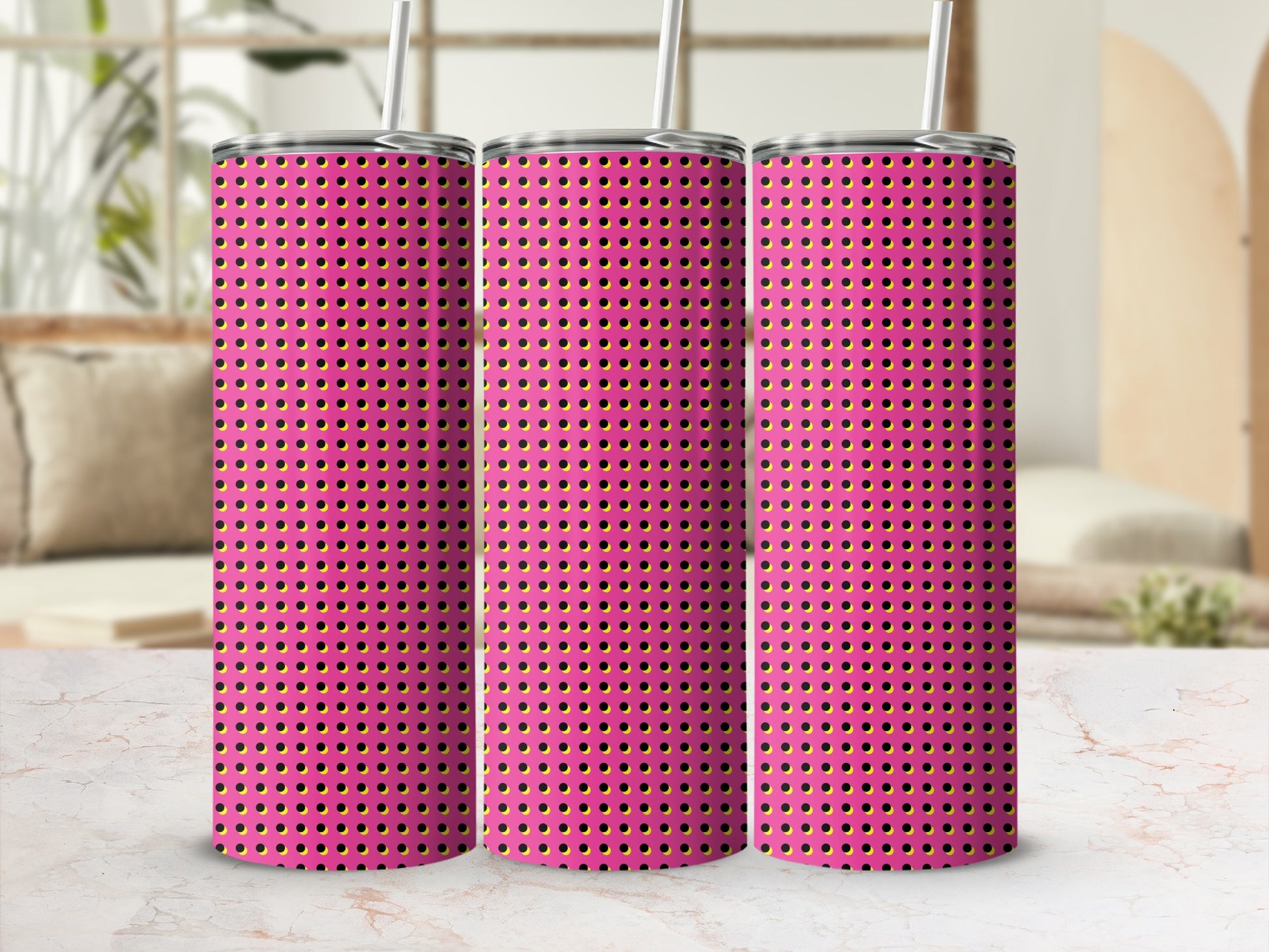 Three pink tumblers with a black and yellow dot pattern and straws.