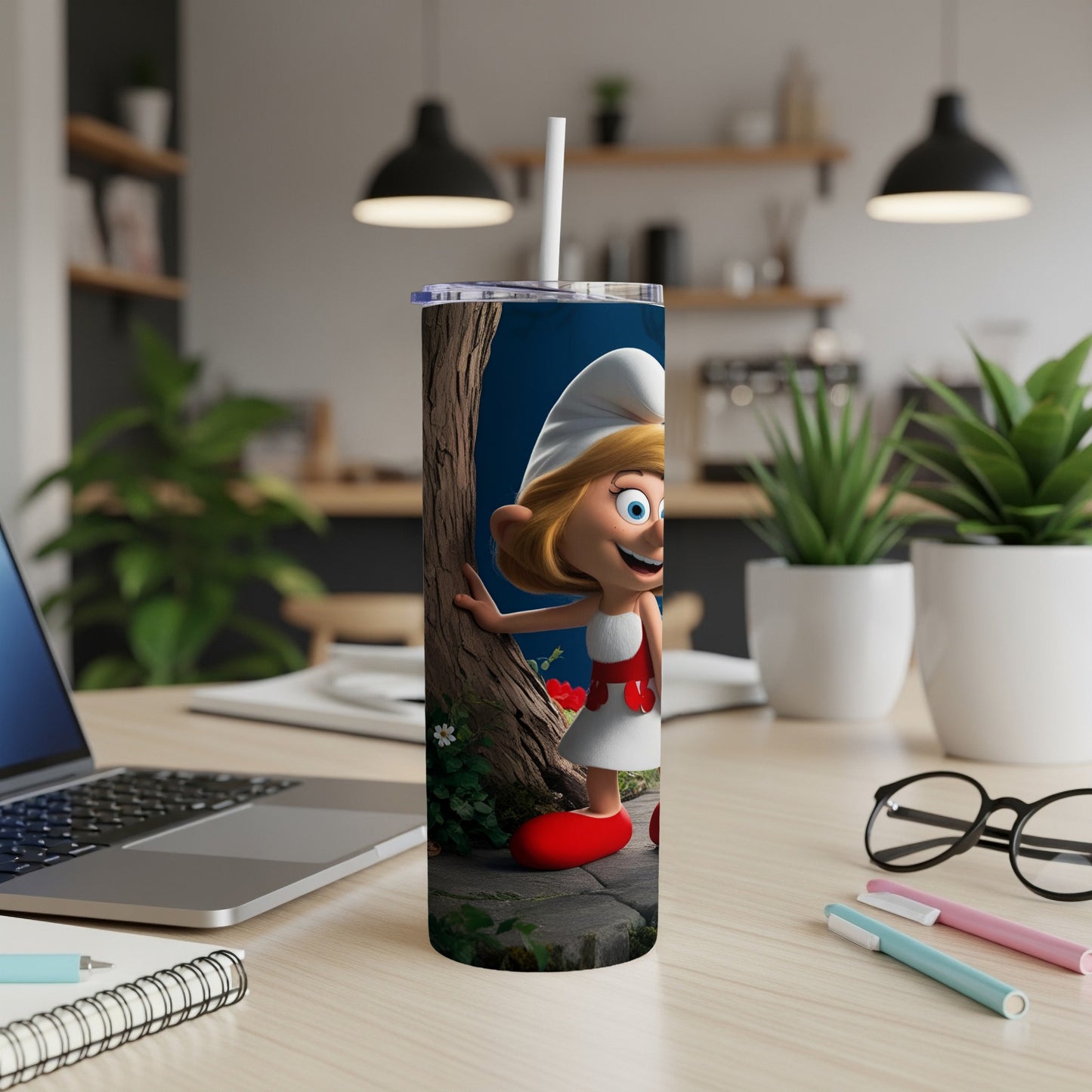 Smurfette character on a white tumbler with a straw on a desk.