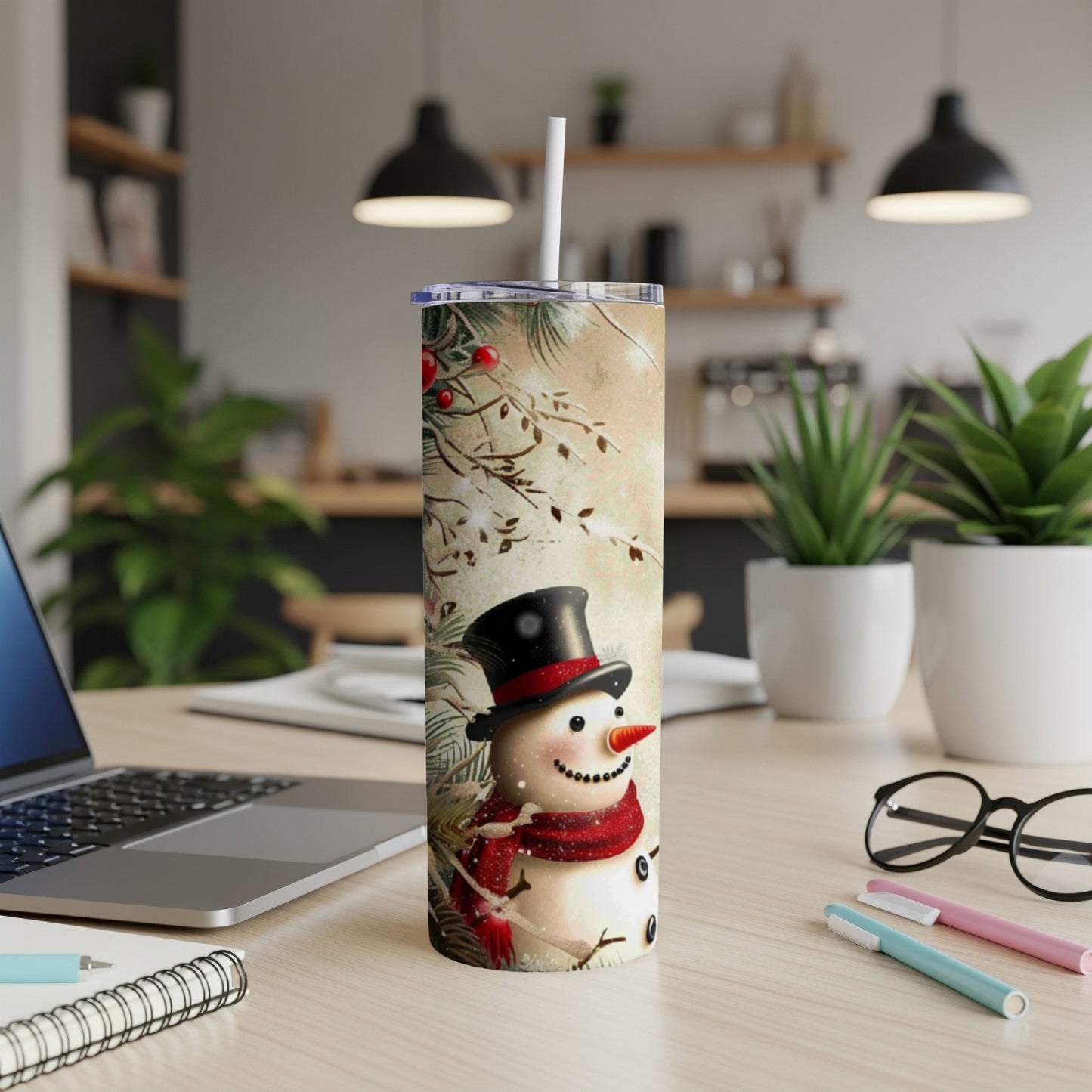 Snowman wearing a top hat and red scarf on a festive tumbler.