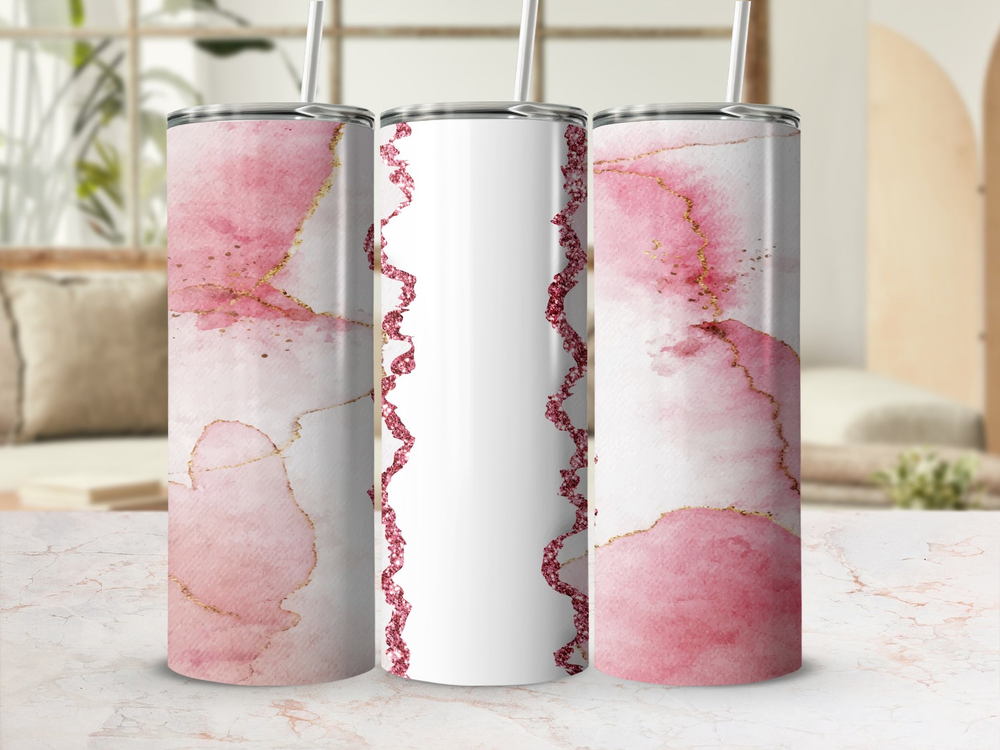 Three glitter and watercolor tumblers with pink and gold accents.