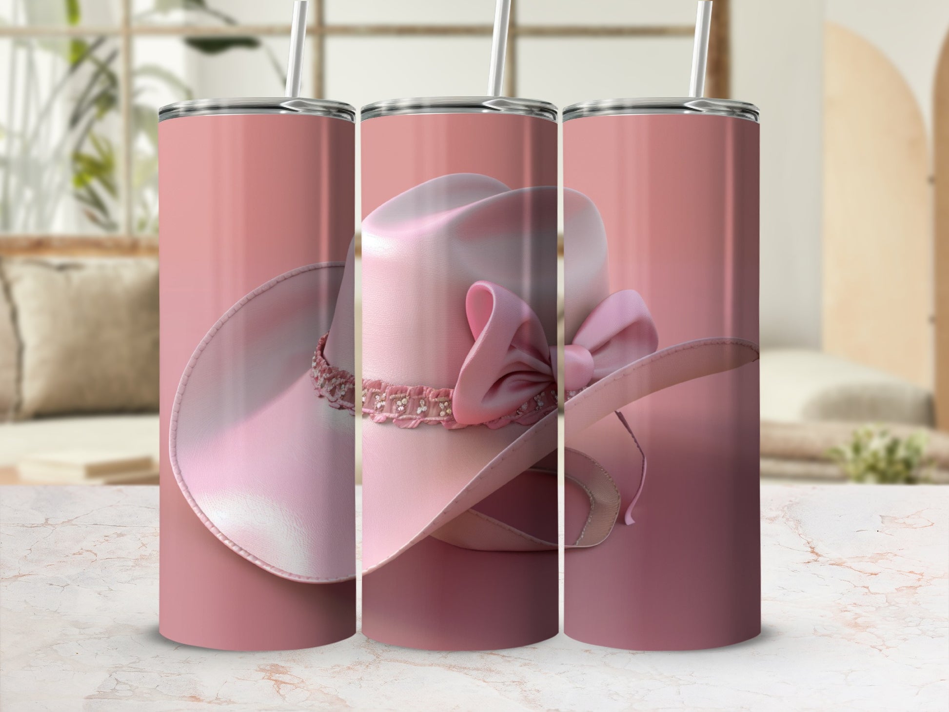 Pink cowgirl hat with bow and rhinestones on a tumbler.